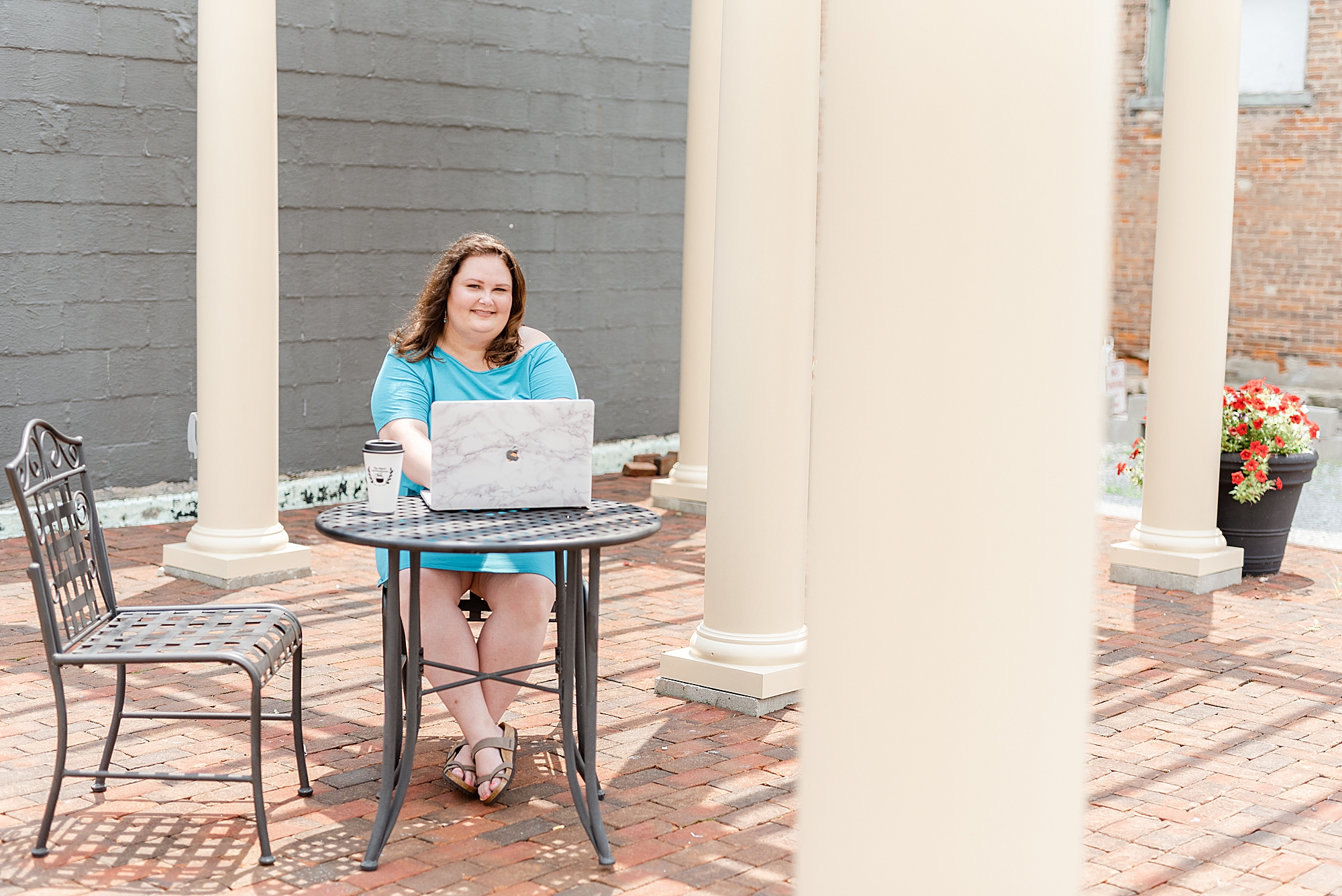 woman works on laptop outside at Haven Collective branding session