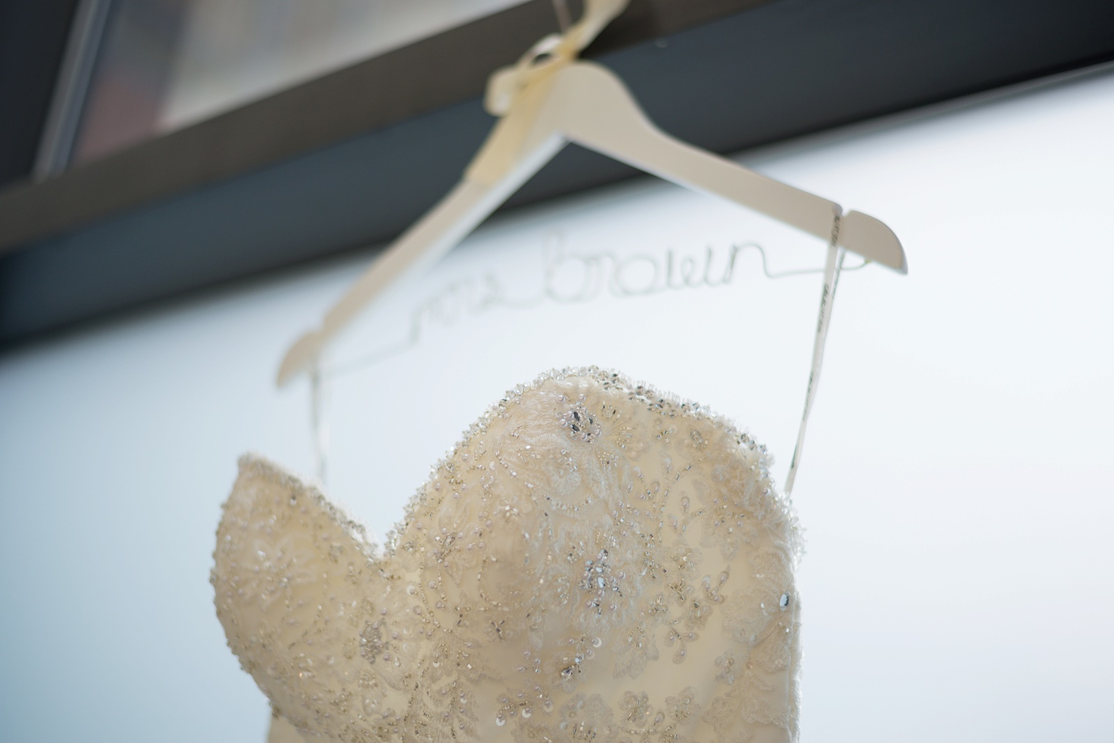 wedding-dress-details-hanging-at-the-hilton-doubletree-suites-hotel