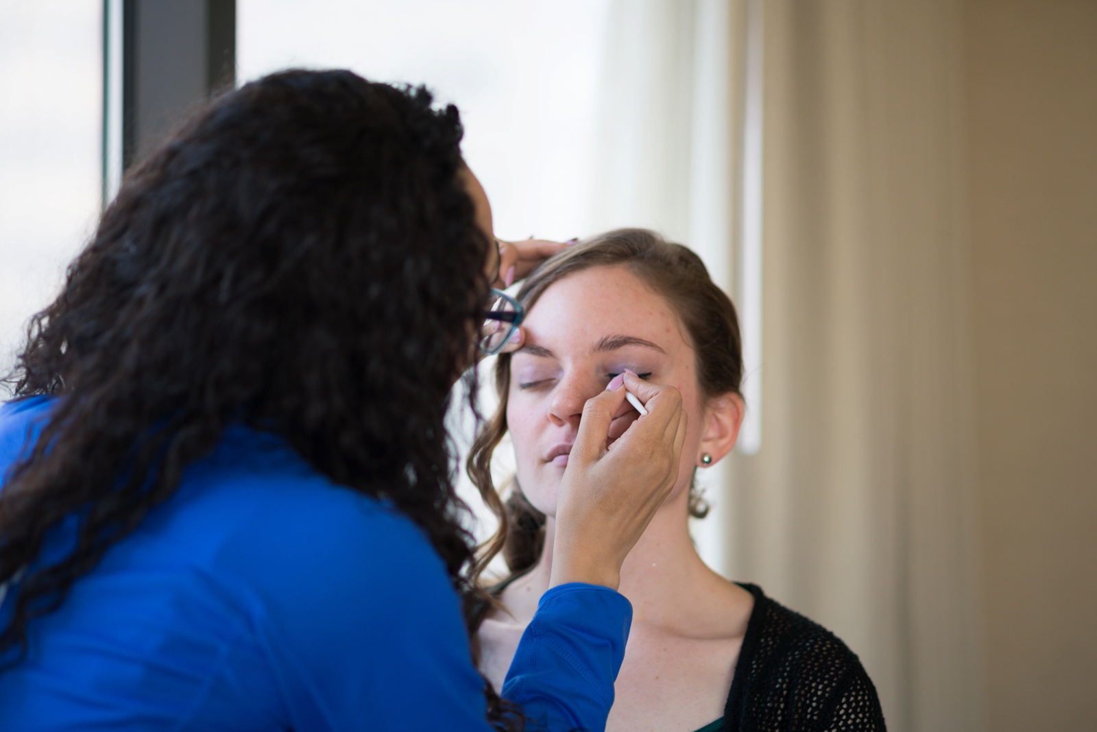 girl-getting-her-makeup-done-for-a-wedding-as-a-bridesmaid