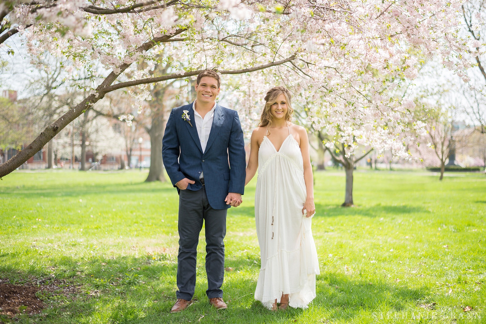 guy-and-girl-standing-underneath-blooming-magnolia-trees