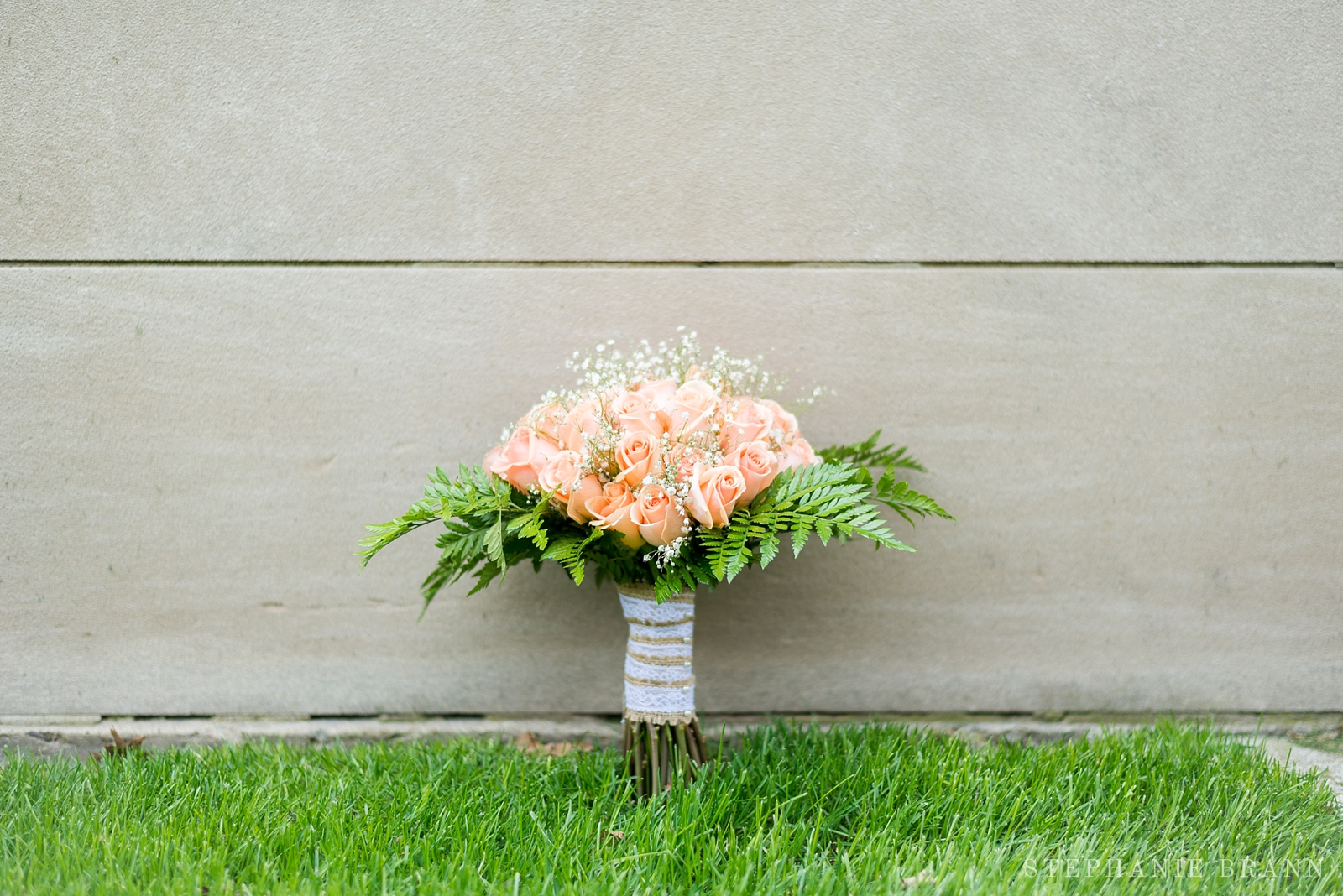 orange roses bouquet with white baby's breath and green fern