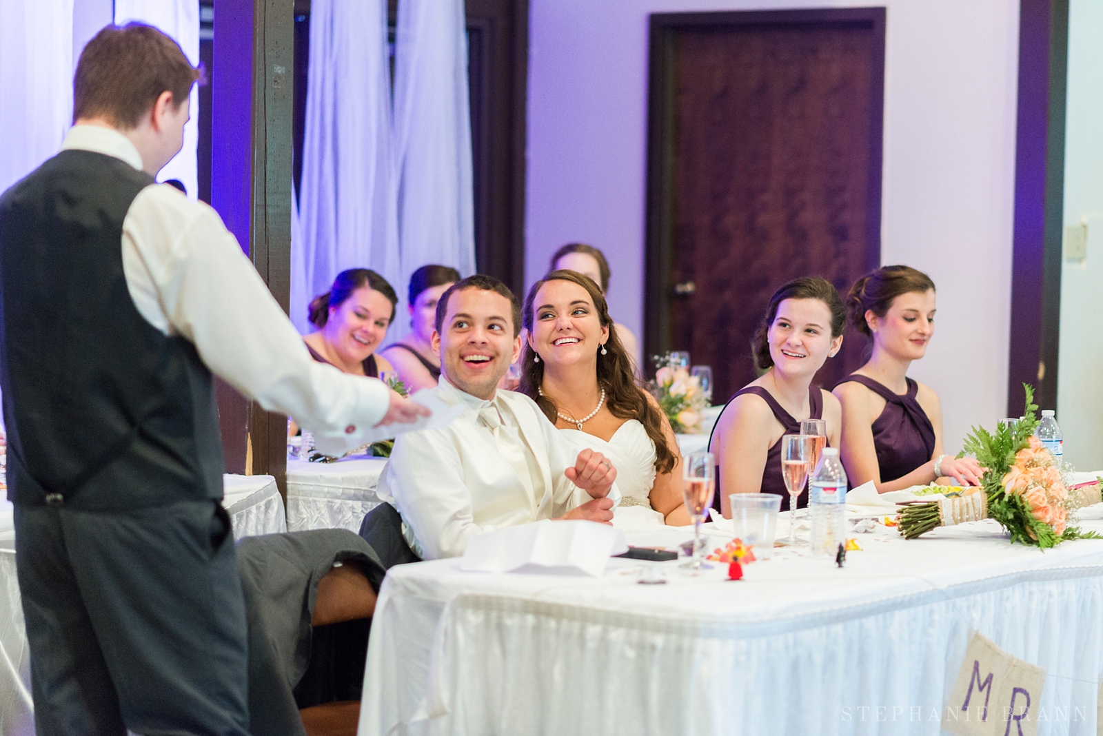 bridal party laughing at the best man's toast