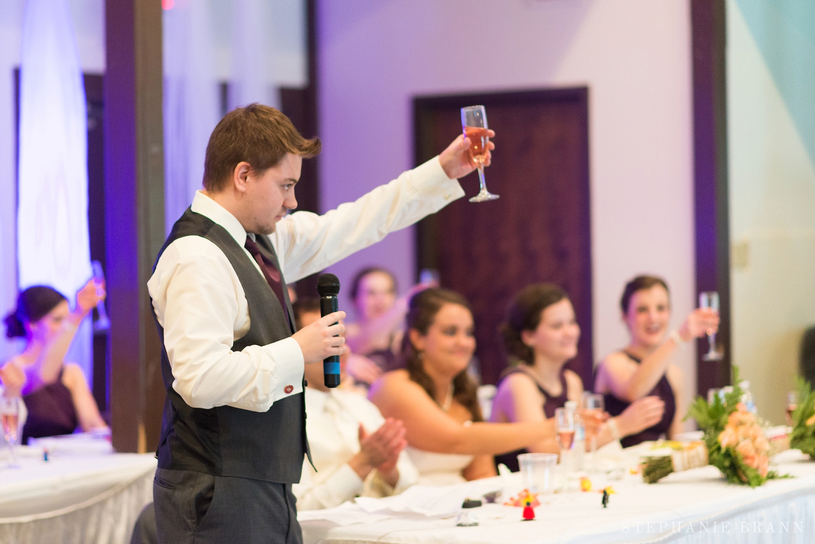 guy holds up glass for a toast