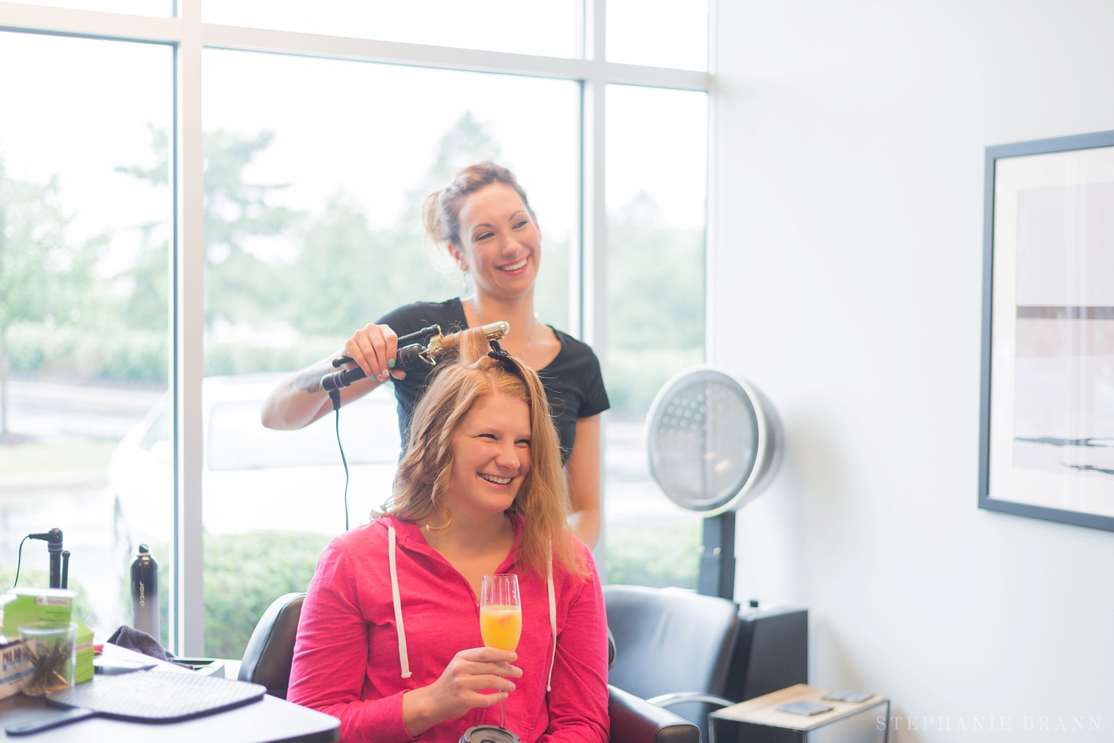 girl-getting-her-hair-curled-by-a-hair-stylist