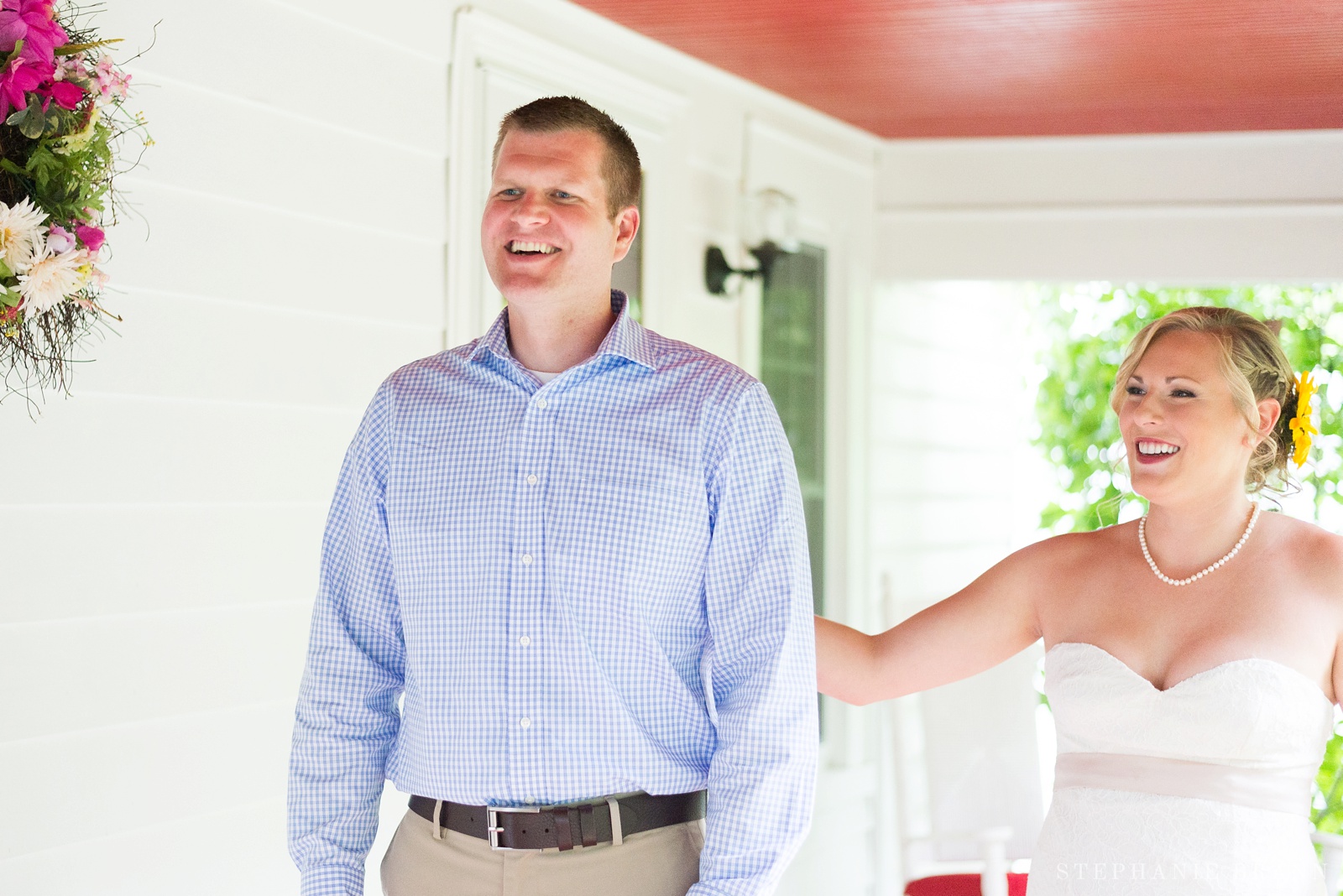 couple-having-their-first-look-on-a-porch