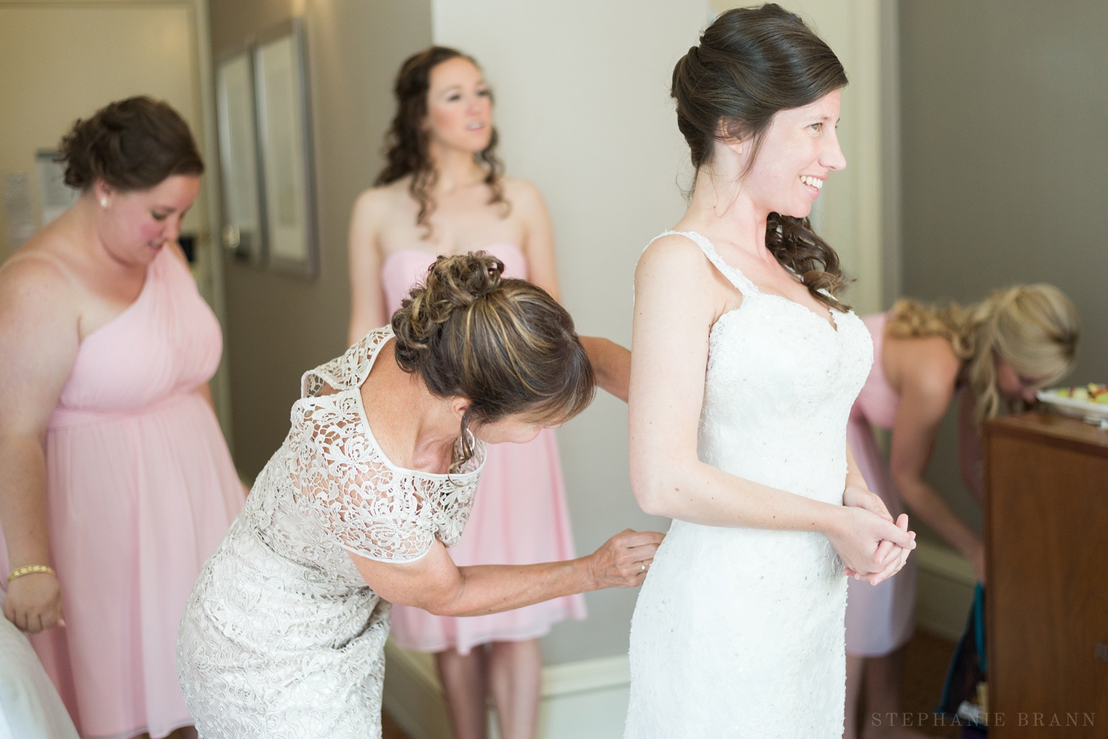 girl-having-her-wedding-dress-zipped-up