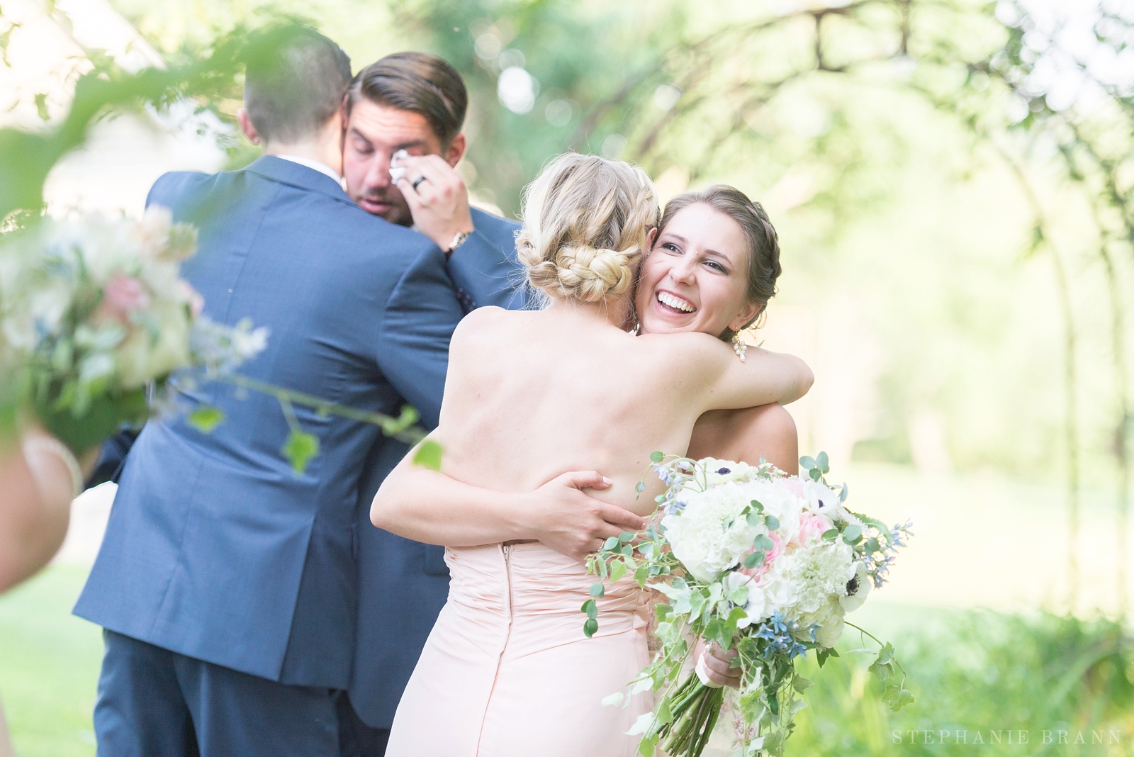 couple-embracing-friends-after-they-just-got-married