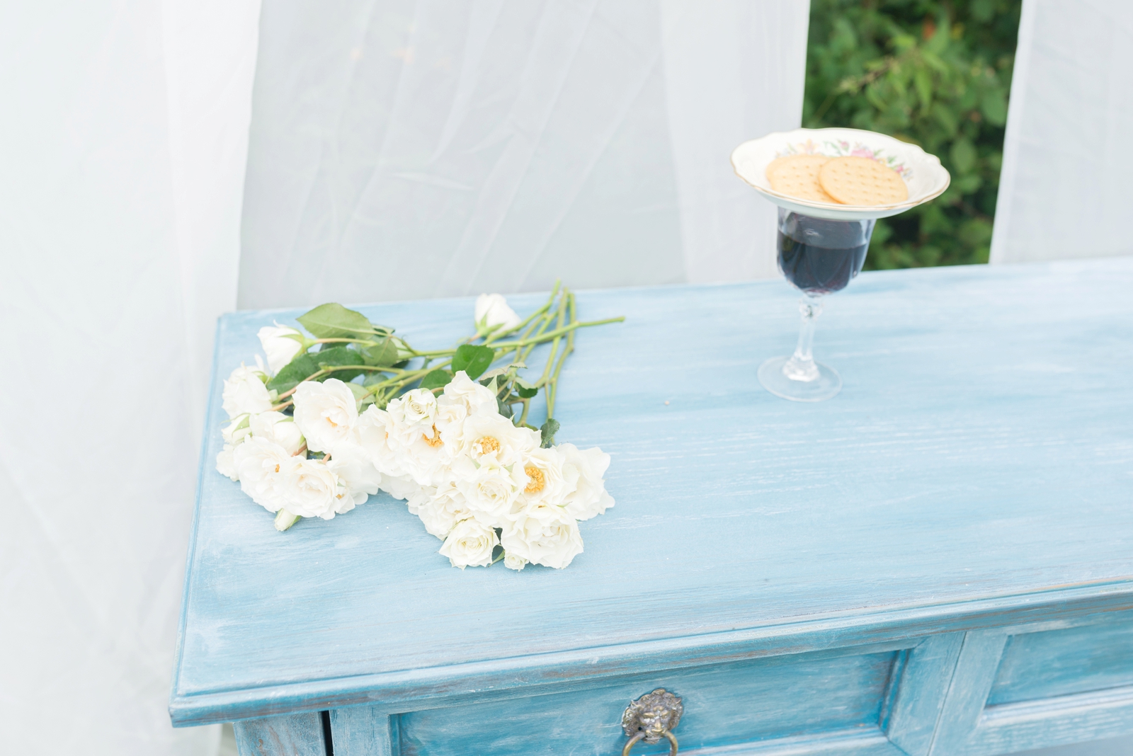 blue-table-with-white-flowers-and-communion