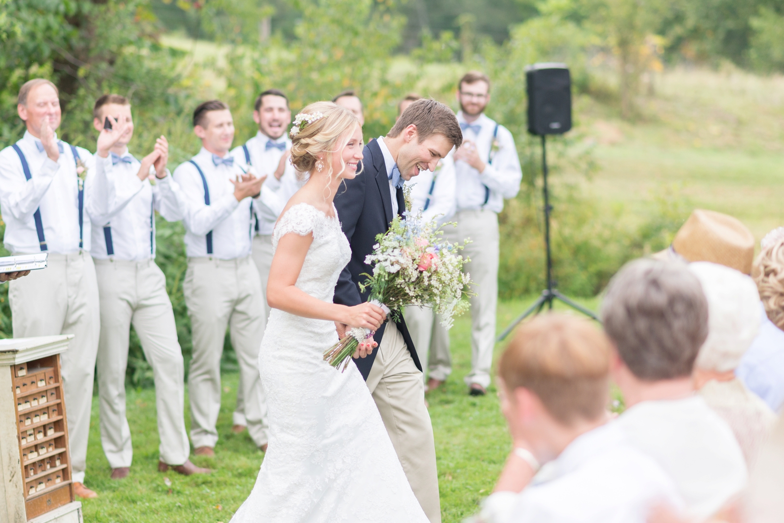 couple-just-married-walking-down-the-aisle-smiling