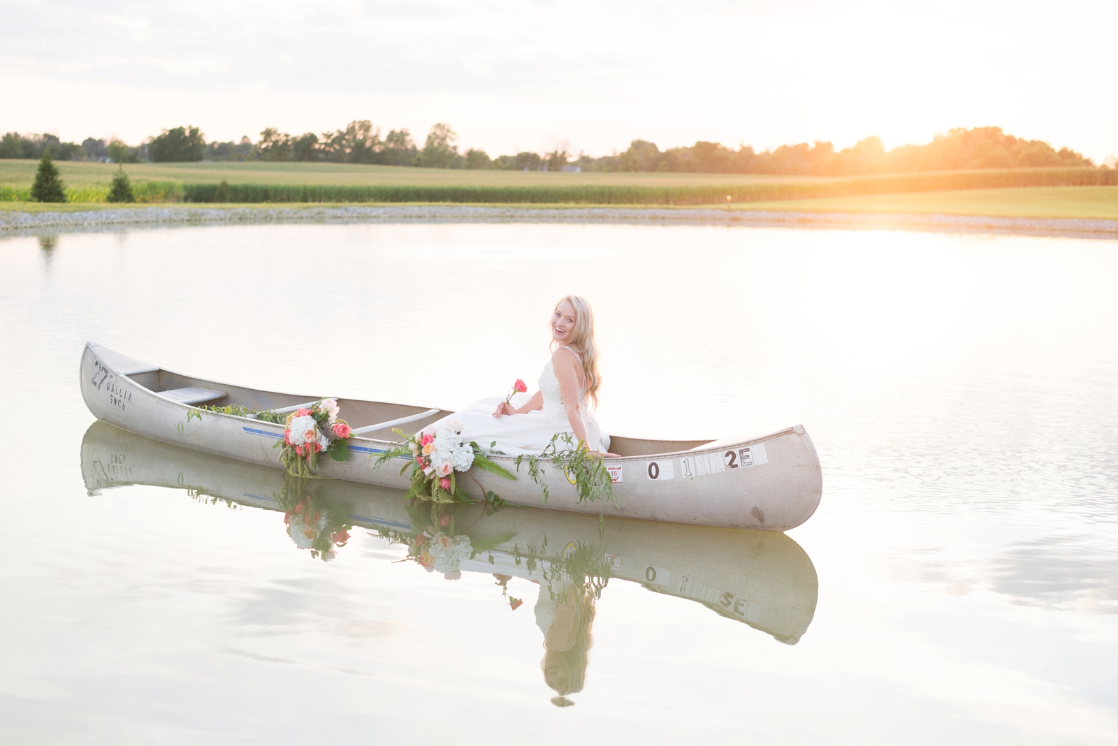 boat-on-a-lake-with-a-bride-inside-for-a-styled-shoot