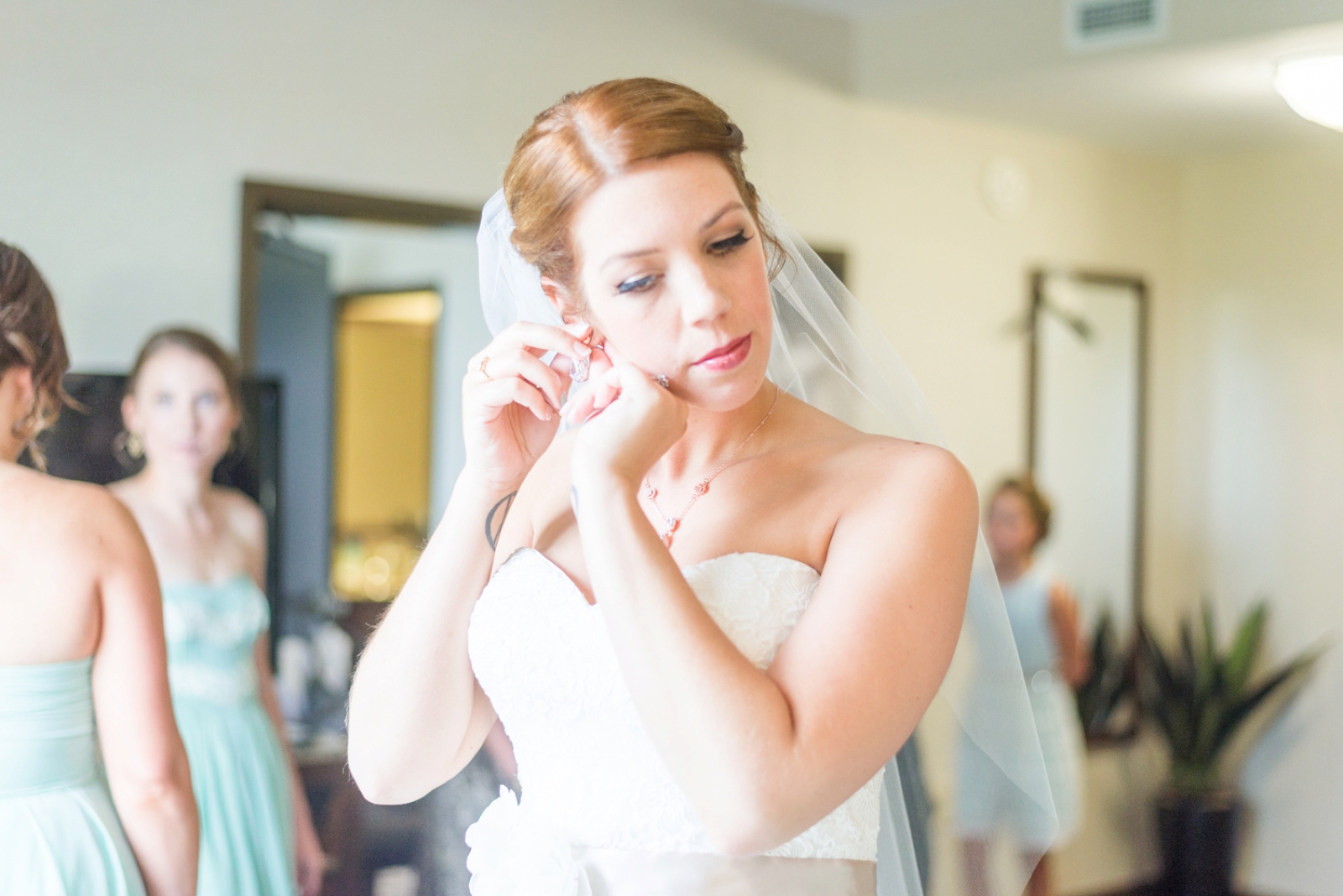 bride-putting-her-earrings-on-in-a-hotel