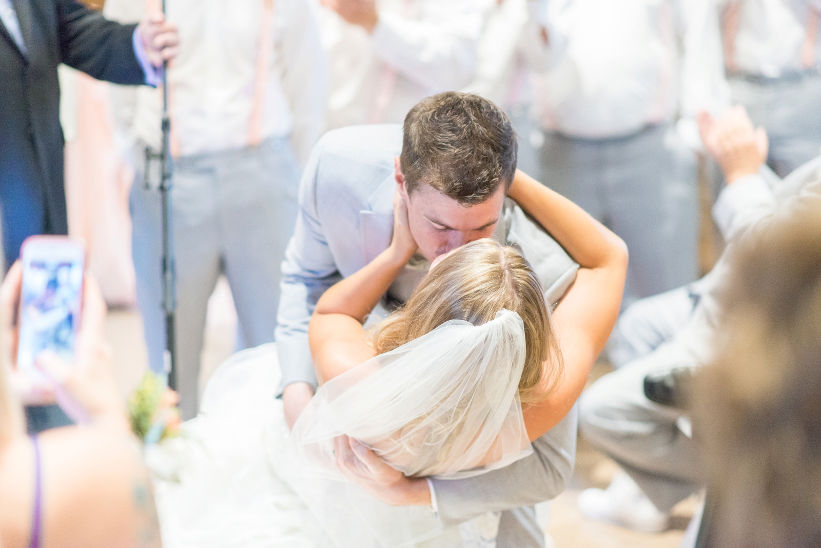 groom-dipping-his-bride-while-kissing