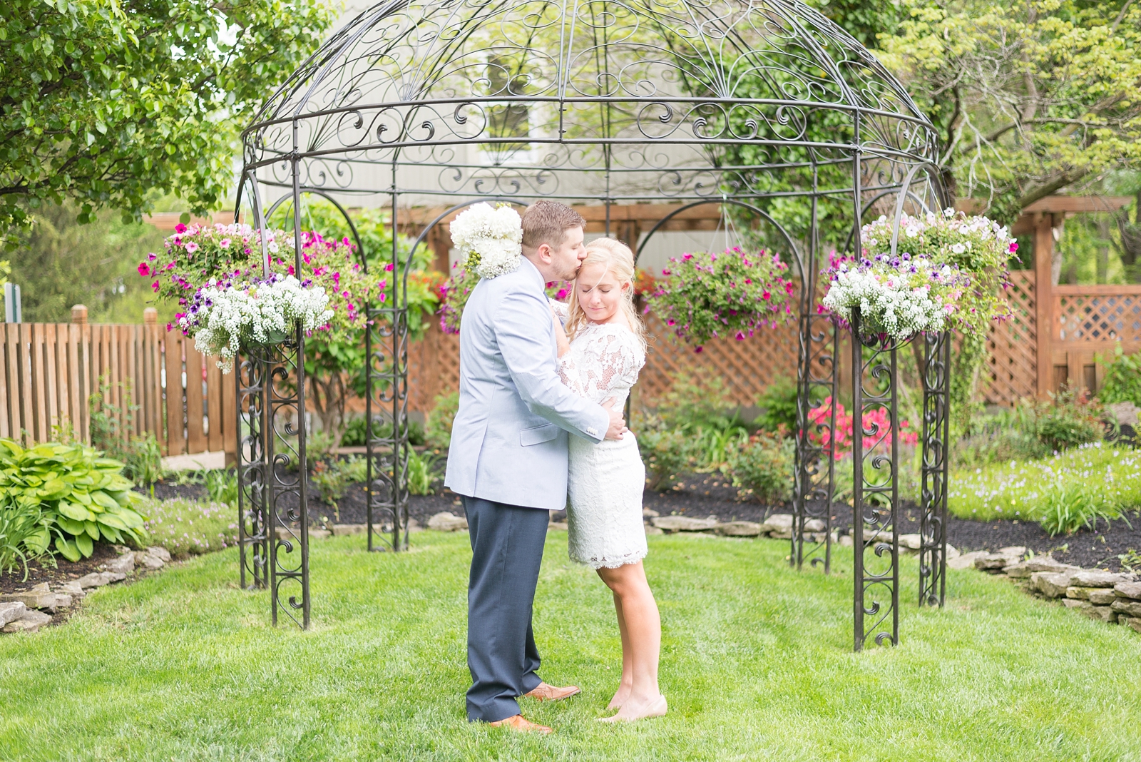 couple-standing-in-a-garden-with-flowers-kissing