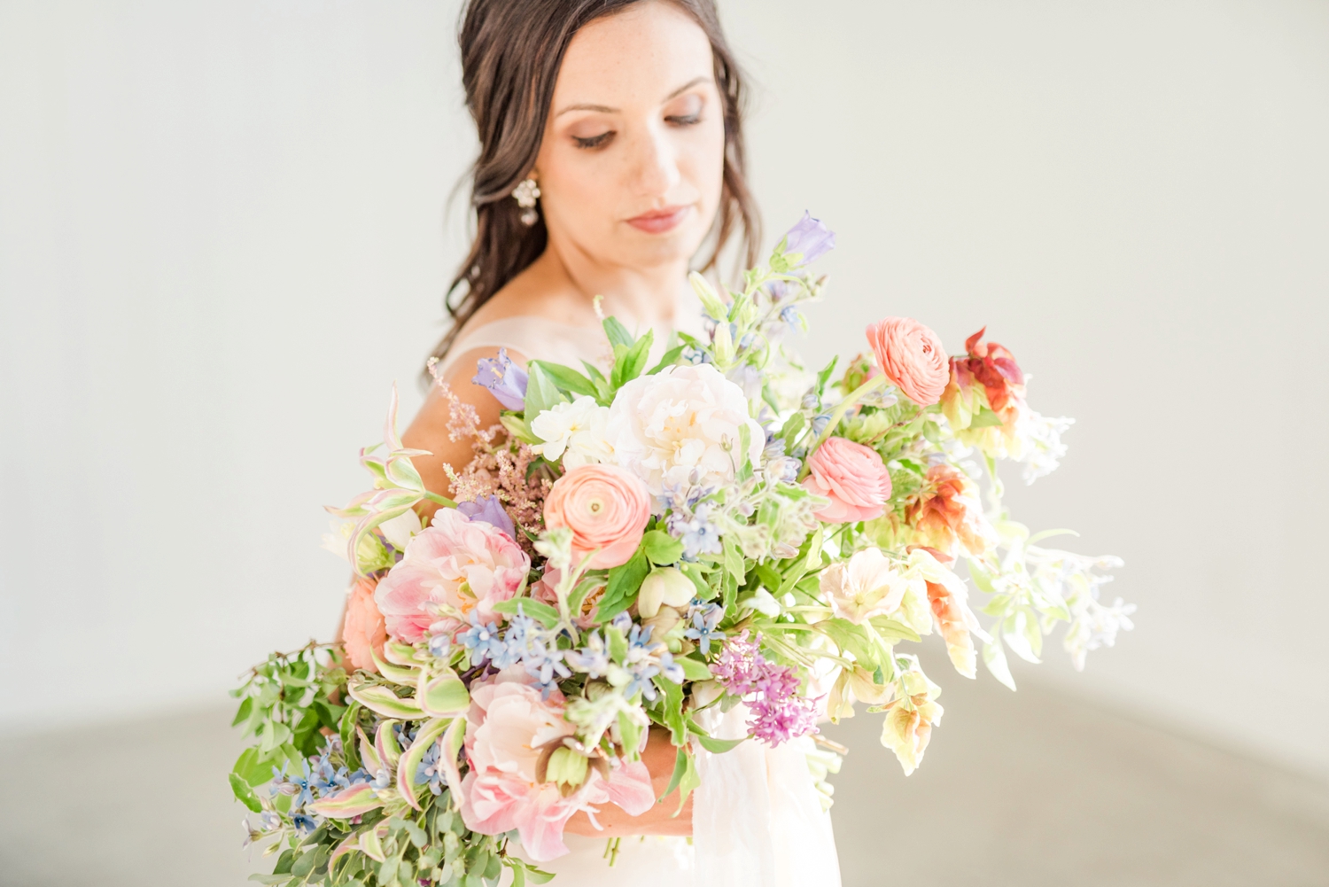 beautiful-peach-blush-and-blue-wedding-bouquet-with-unique-summer-flowers