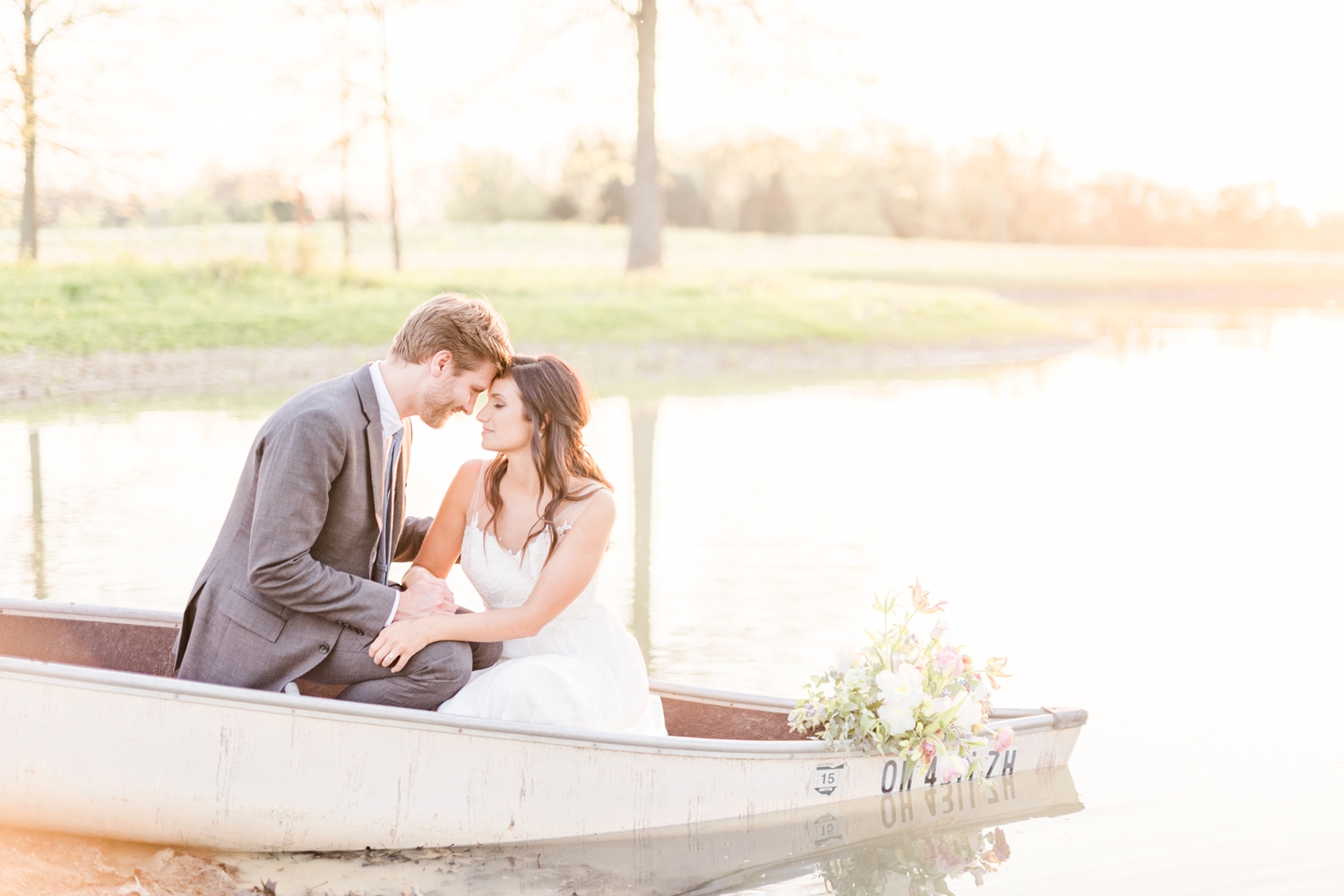 bride-and-groom-wedding-portraits-in-a-boat-at-jorgensen-farms-oak-grove