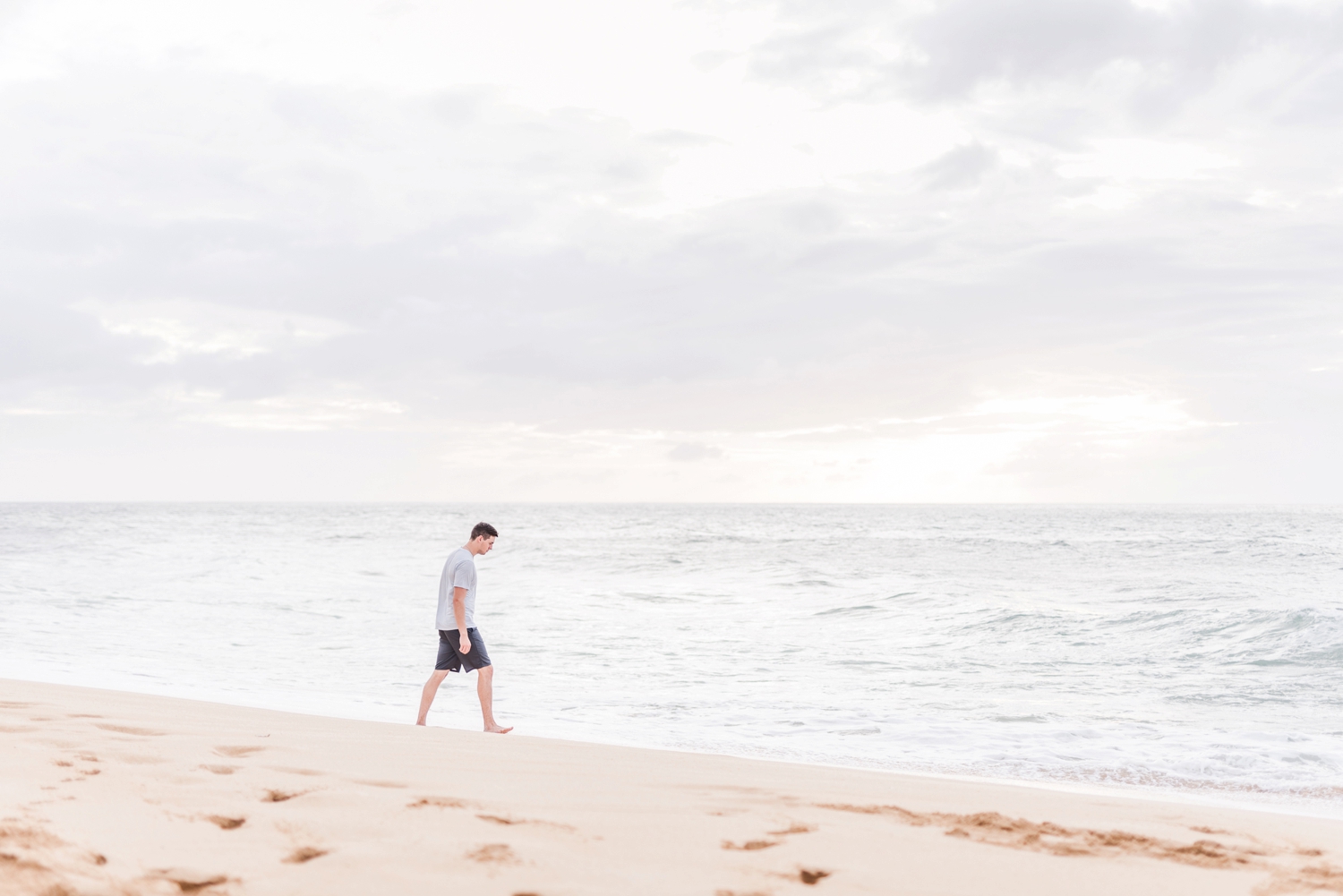 man-walking-along-side-the-ocean-in-hawaii
