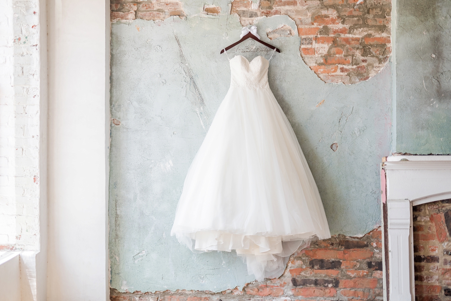 wedding-dress-hanging-on-an-industrial-wall