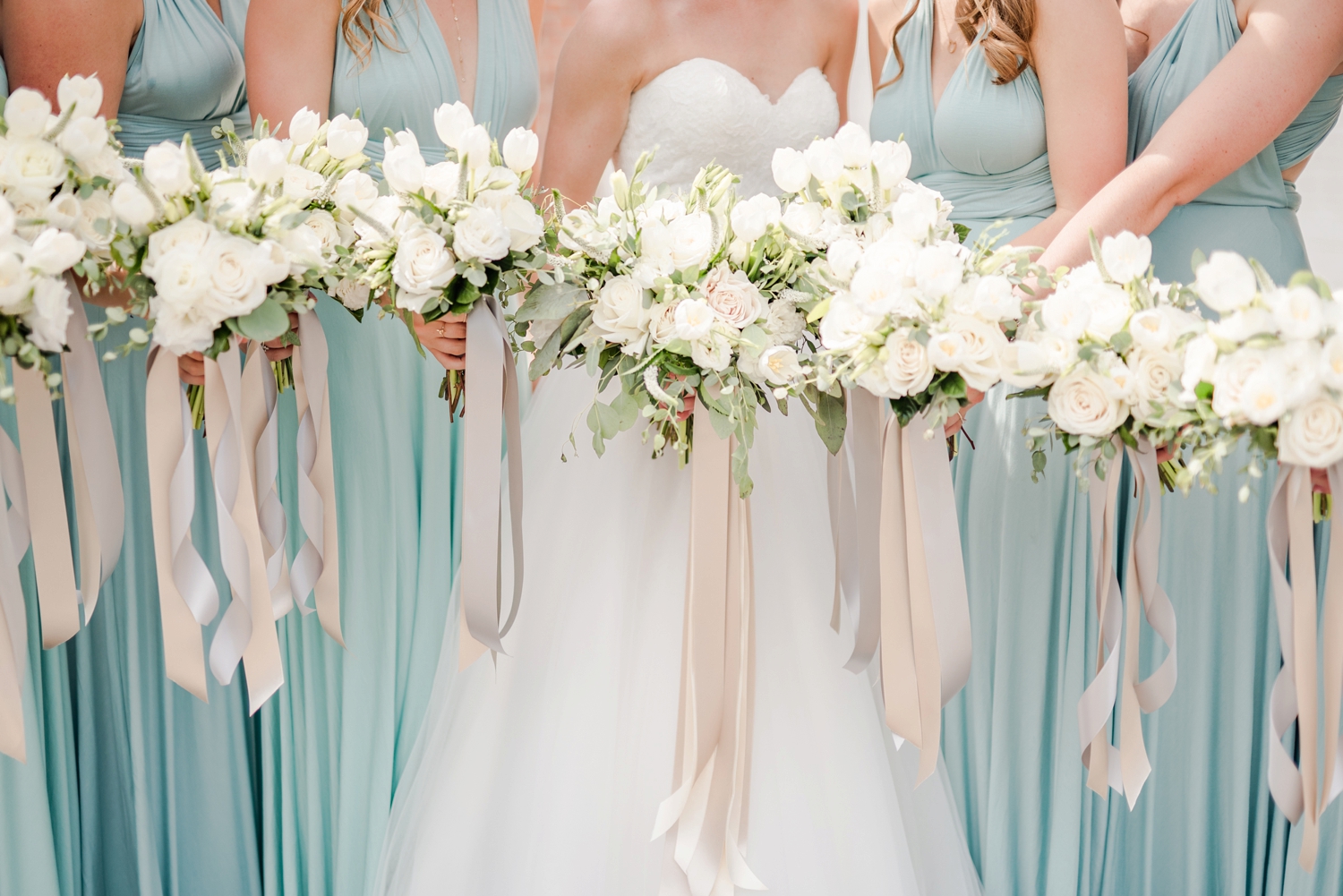 light-teal-bridesmaids-dresses-with-fluffy-white-bouquets-with-cream-ribbon