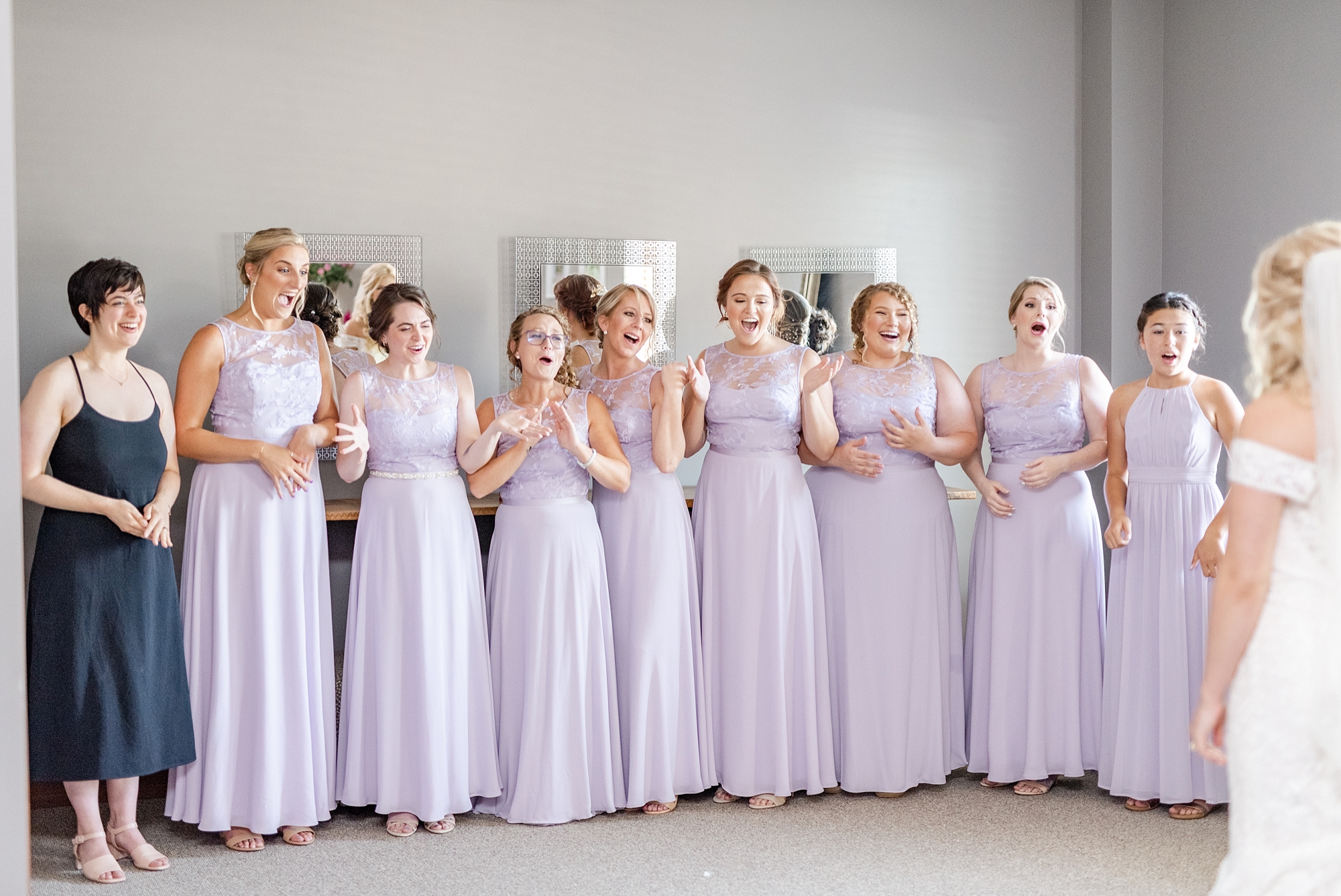 bridesmaids react to seeing bride in gown and veil for the first time