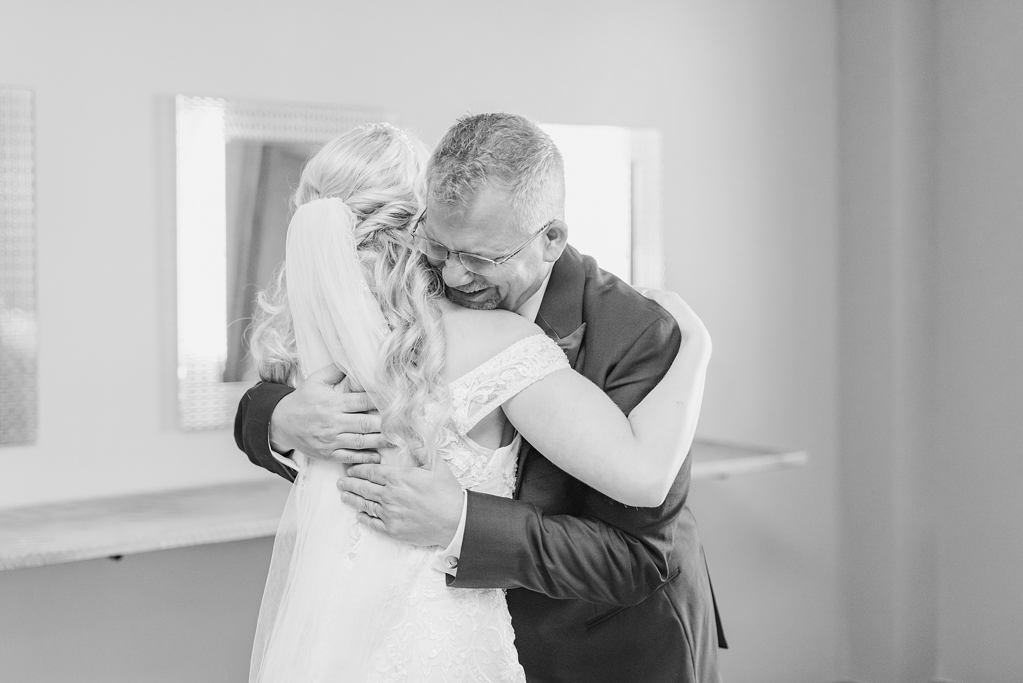 dad hugs daughter during first look on wedding day