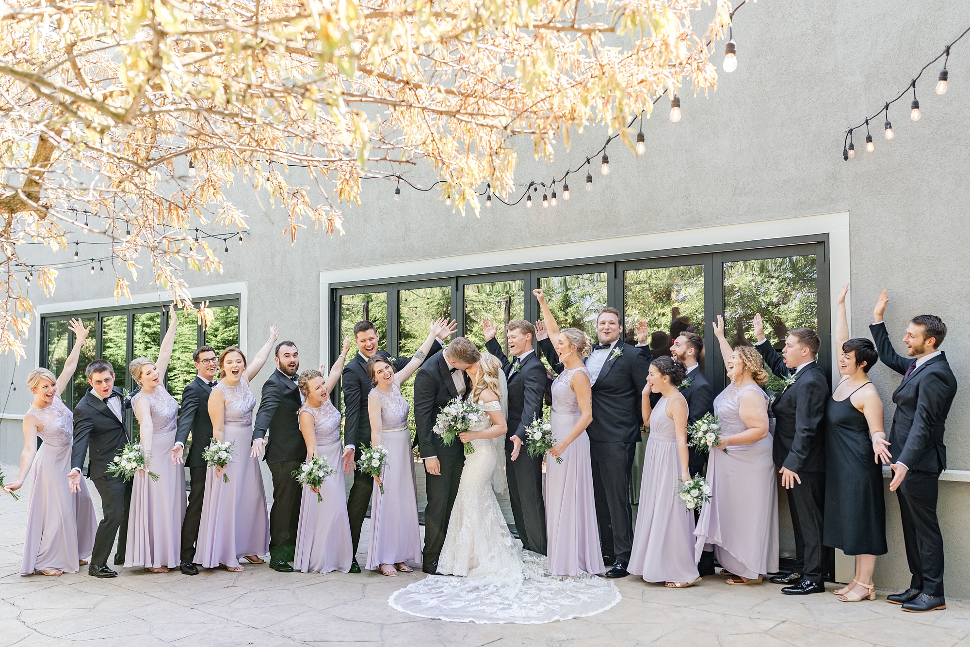 bridal party in purple and black pose along Brookshire for Stephanie Kase Photography