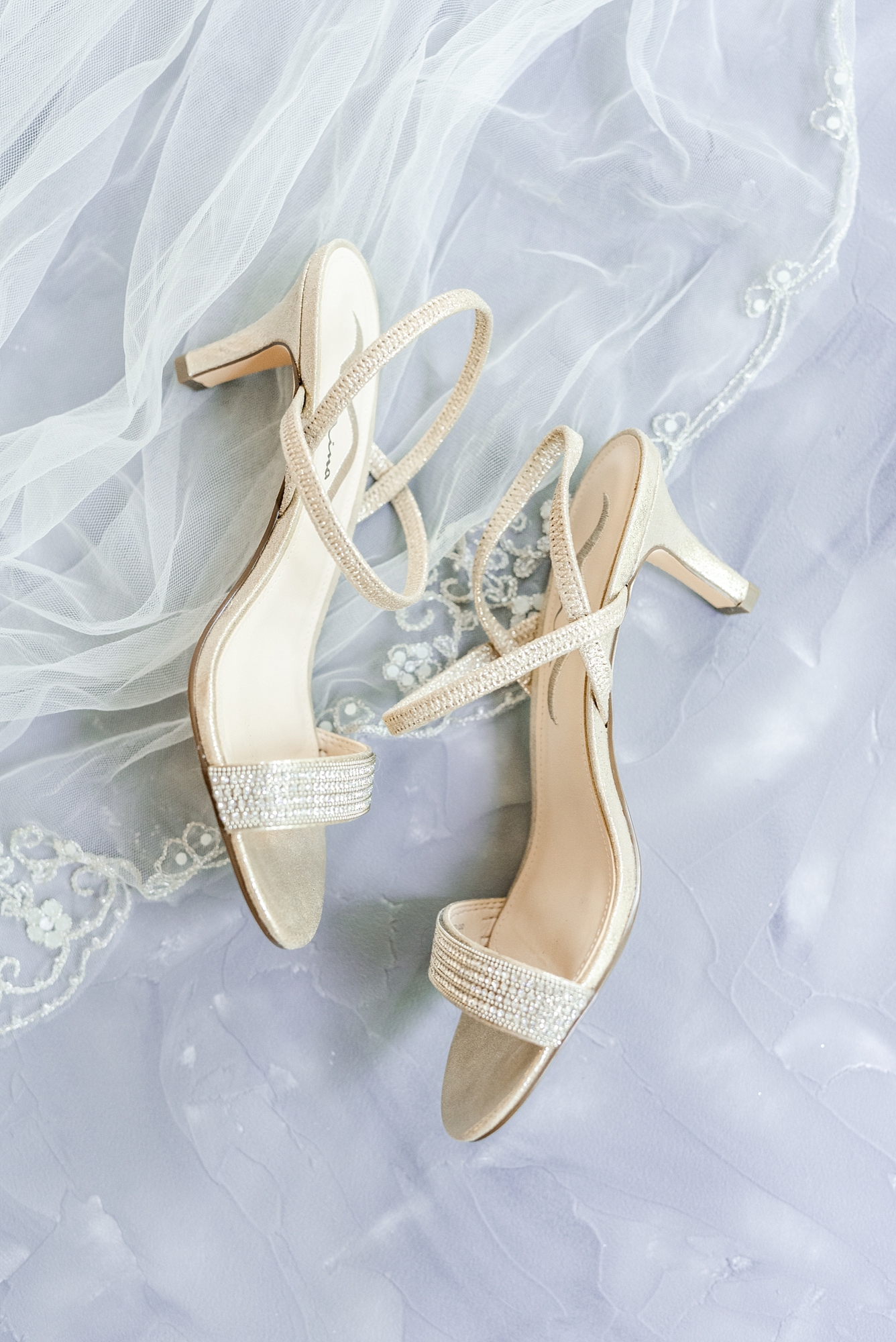 bride's ivory heels lay on veil for Brookshire wedding day