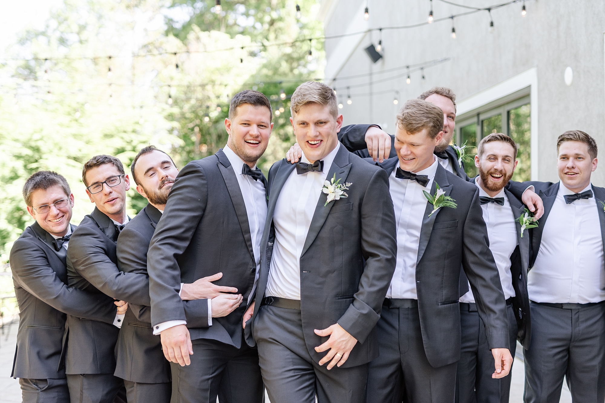 groom and groomsmen goof off during wedding party portraits with Stephanie Kase Photography