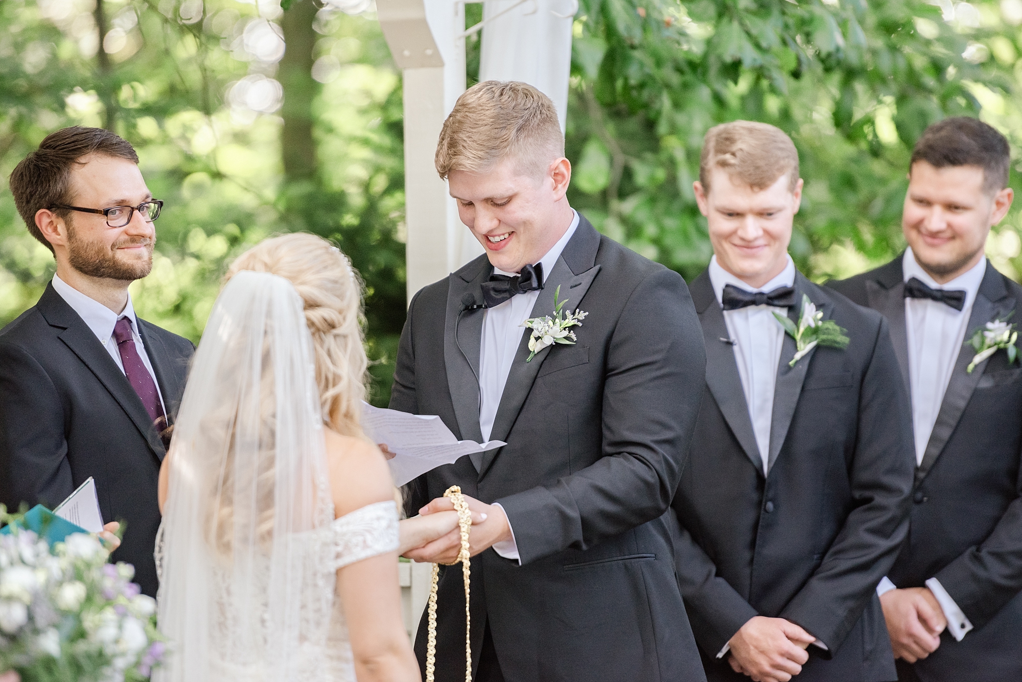 bride and groom exchange vows during hand binding ceremony in ohio