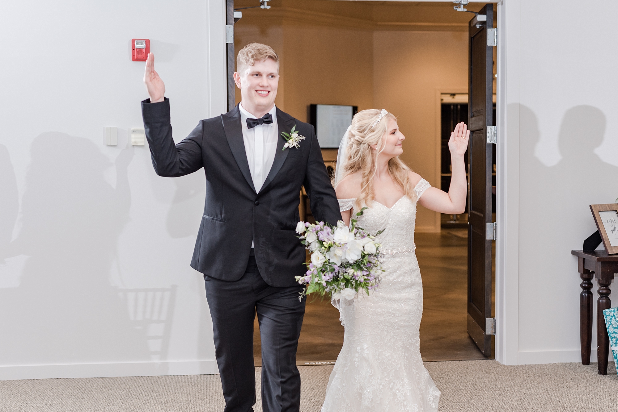bride and groom enter wedding reception at Brookshire waving