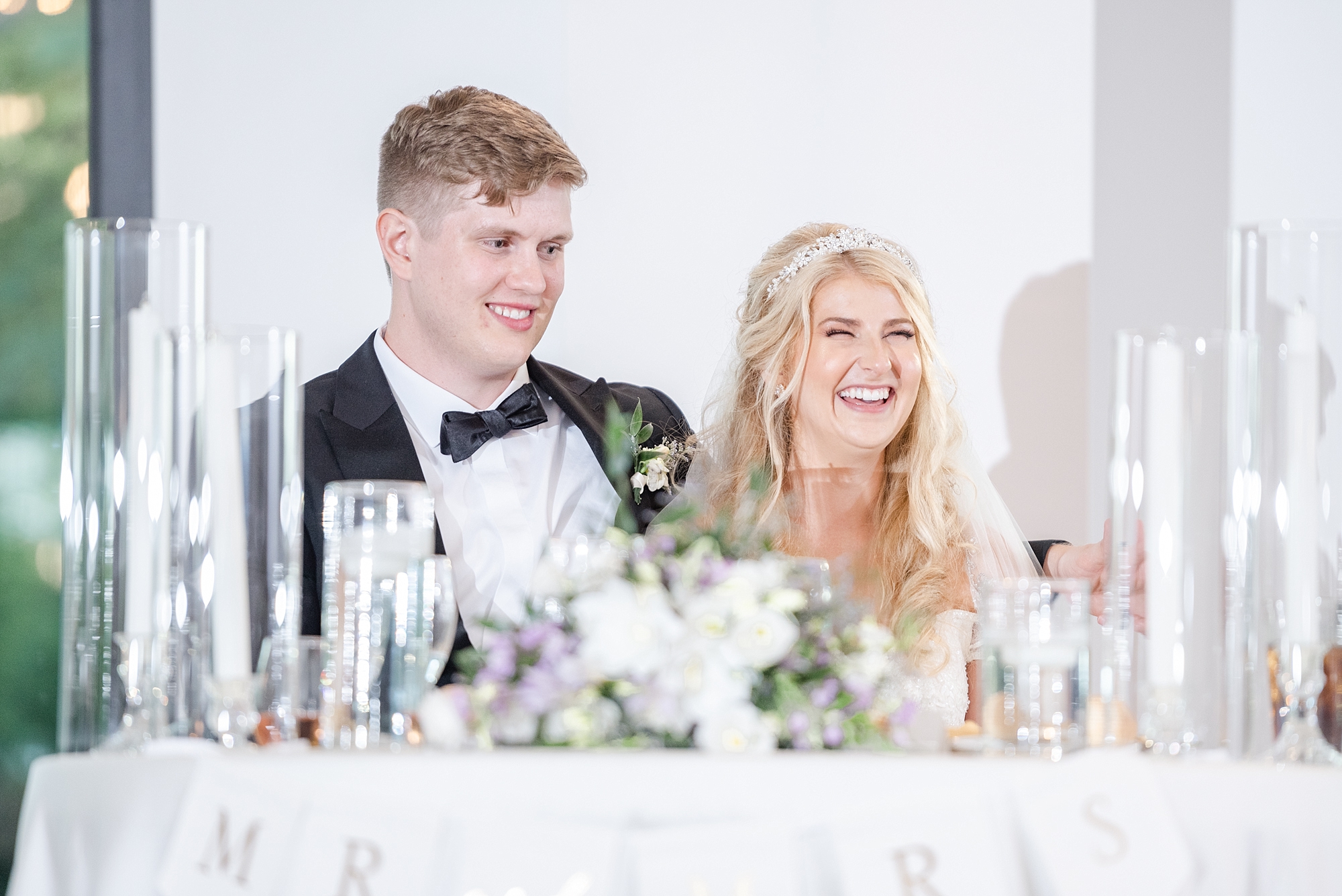 newlyweds laugh during toasts at Brookshire wedding reception