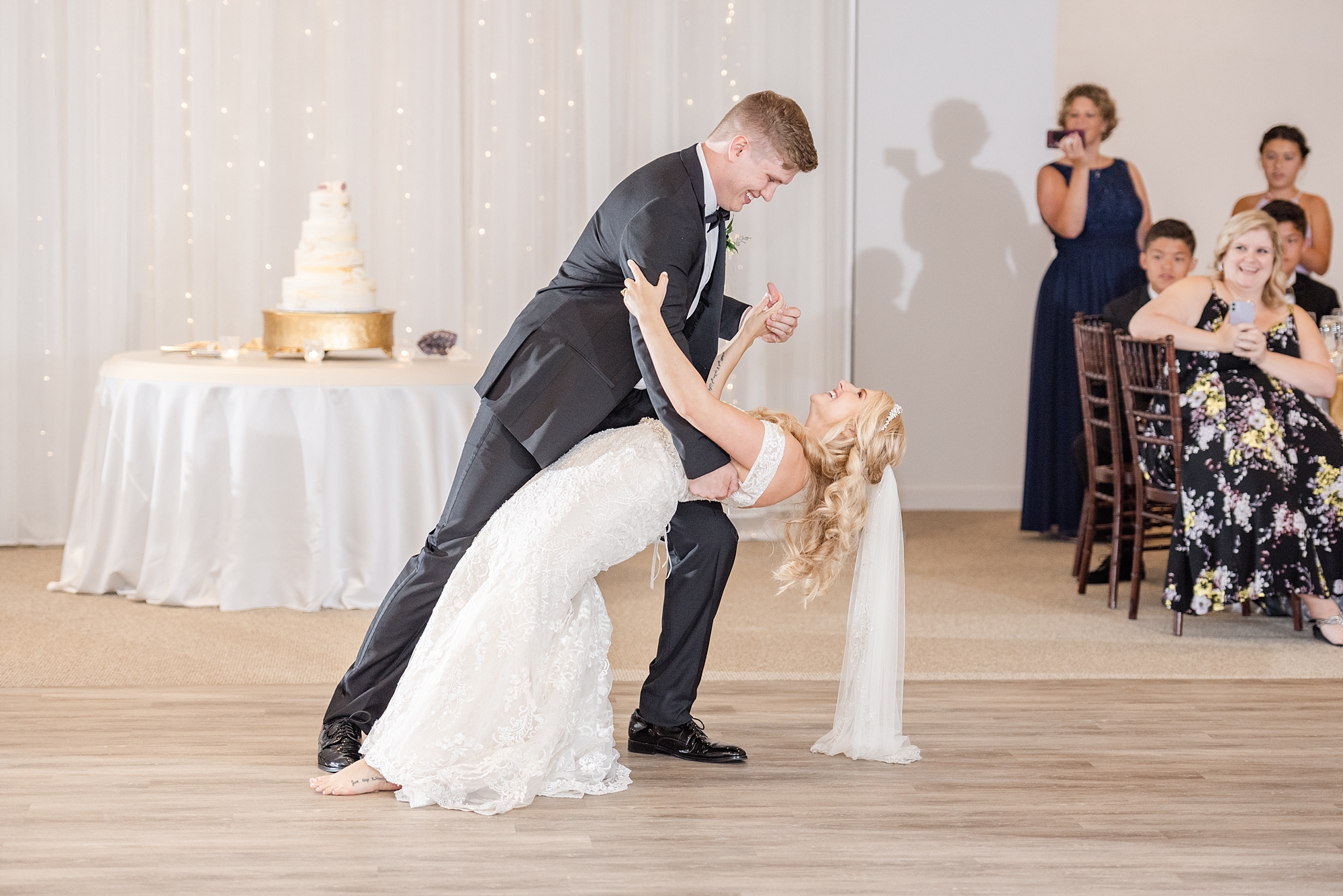 groom dips bride during first dance at Brookshire wedding reception