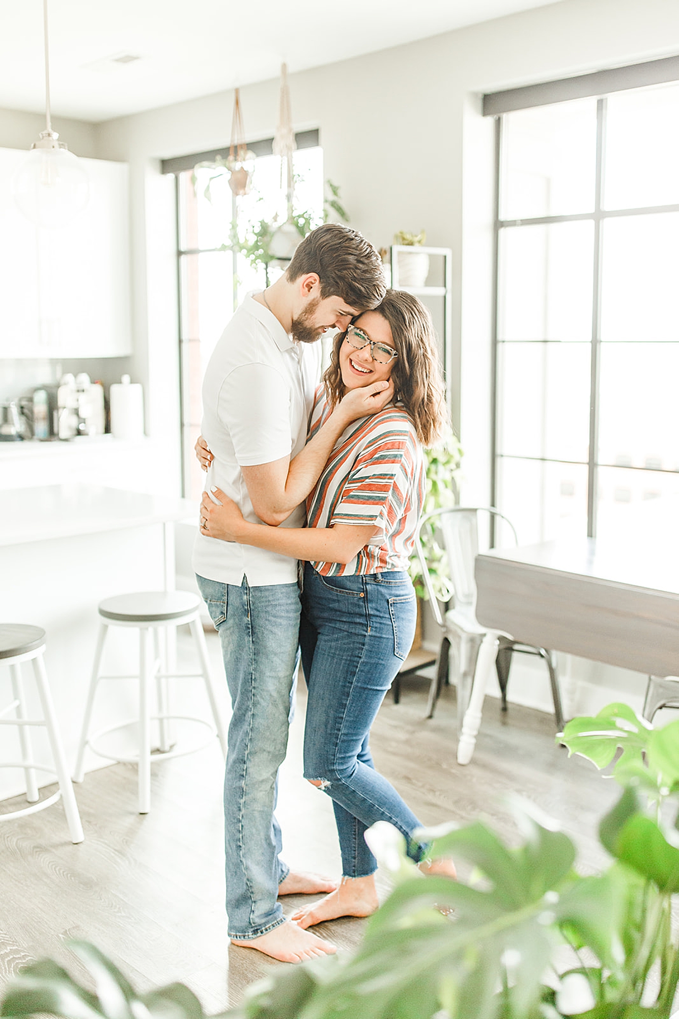 husband and wife hug at home during lifestyle portrait session