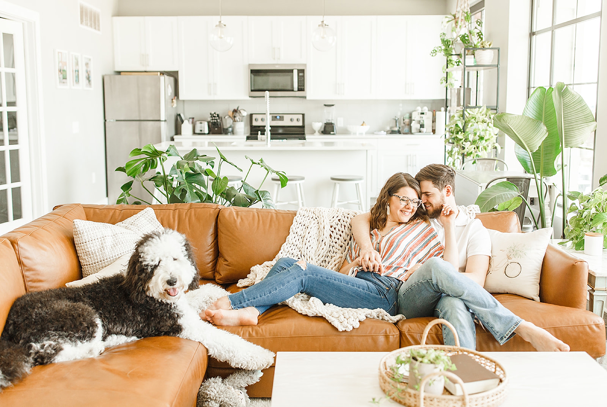 couple relaxes on couch during lifestyle third anniversary photos