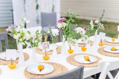 place settings at outdoor baby shower with citrus theme