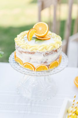 orange cake with orange slices on top for baby shower