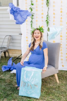 pregnant mom opens baby gift during baby shower