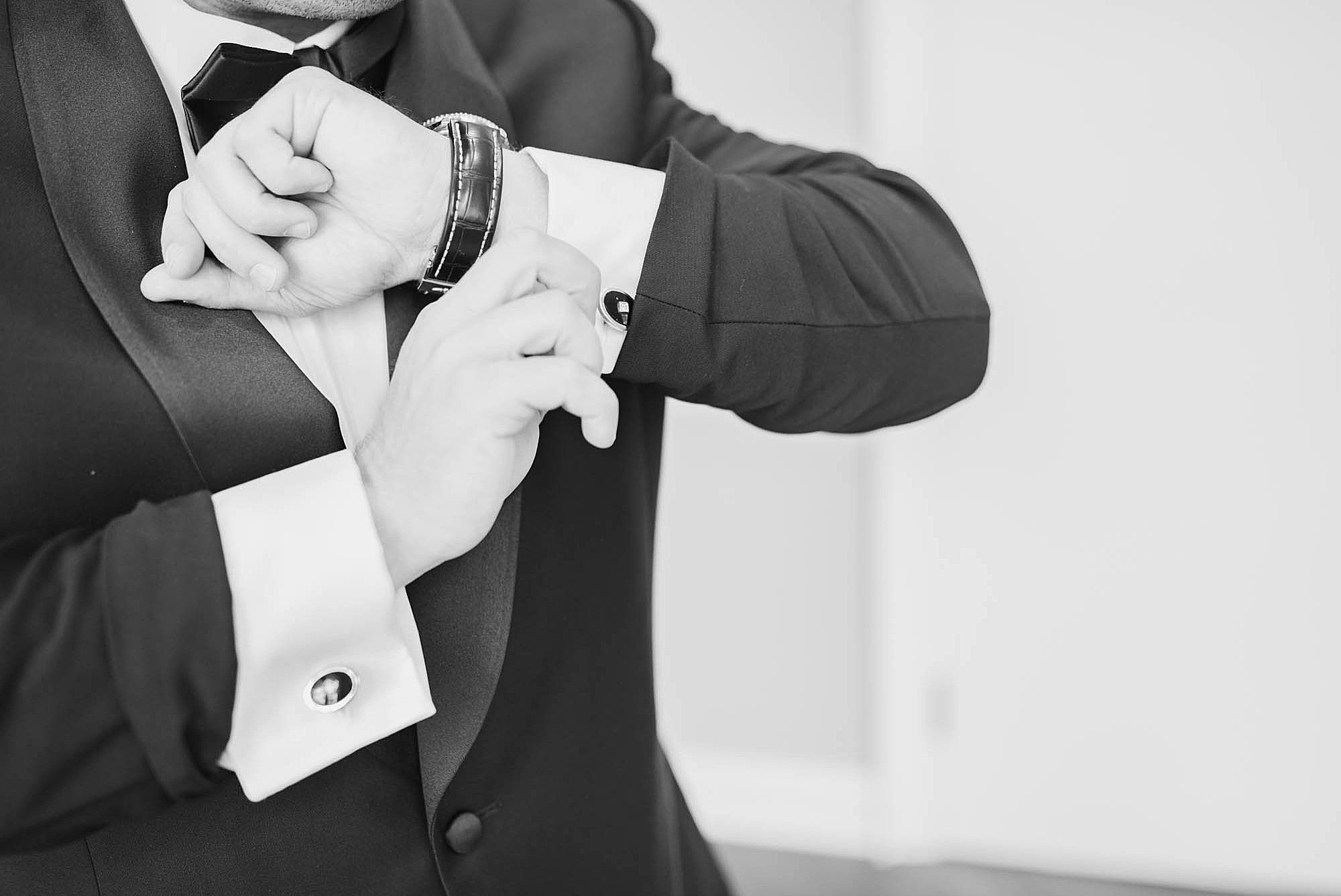groom adjusts cufflinks for Ohio wedding