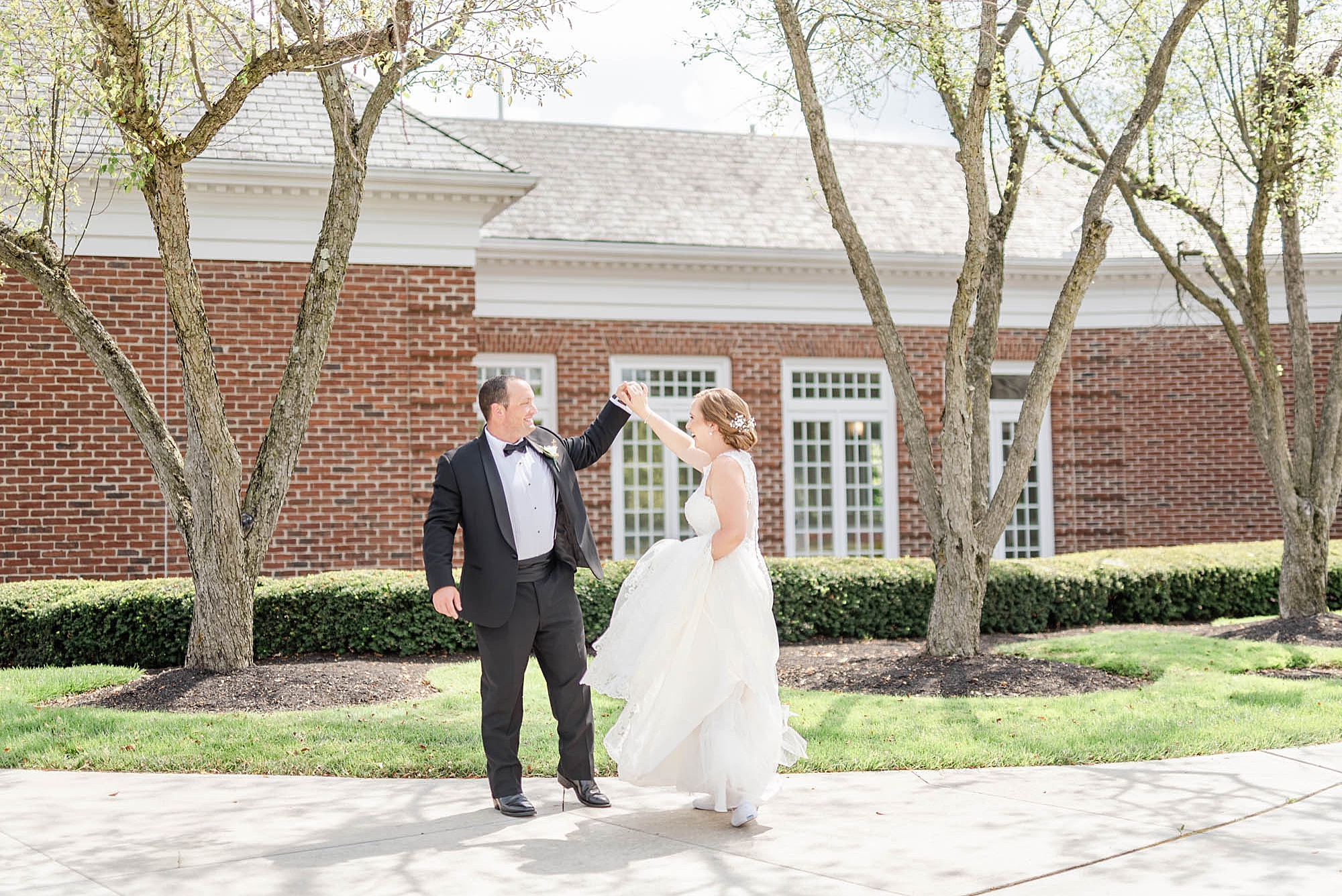 groom twirls bride during portraits in Columbus OH