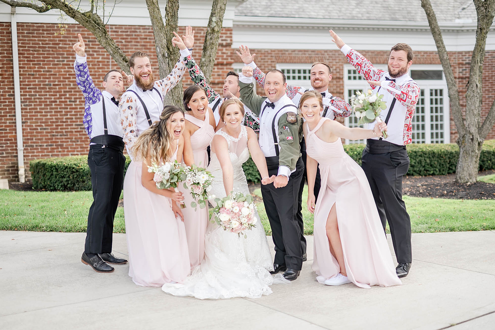 bridal party cheers with groomsmen in custom shirts