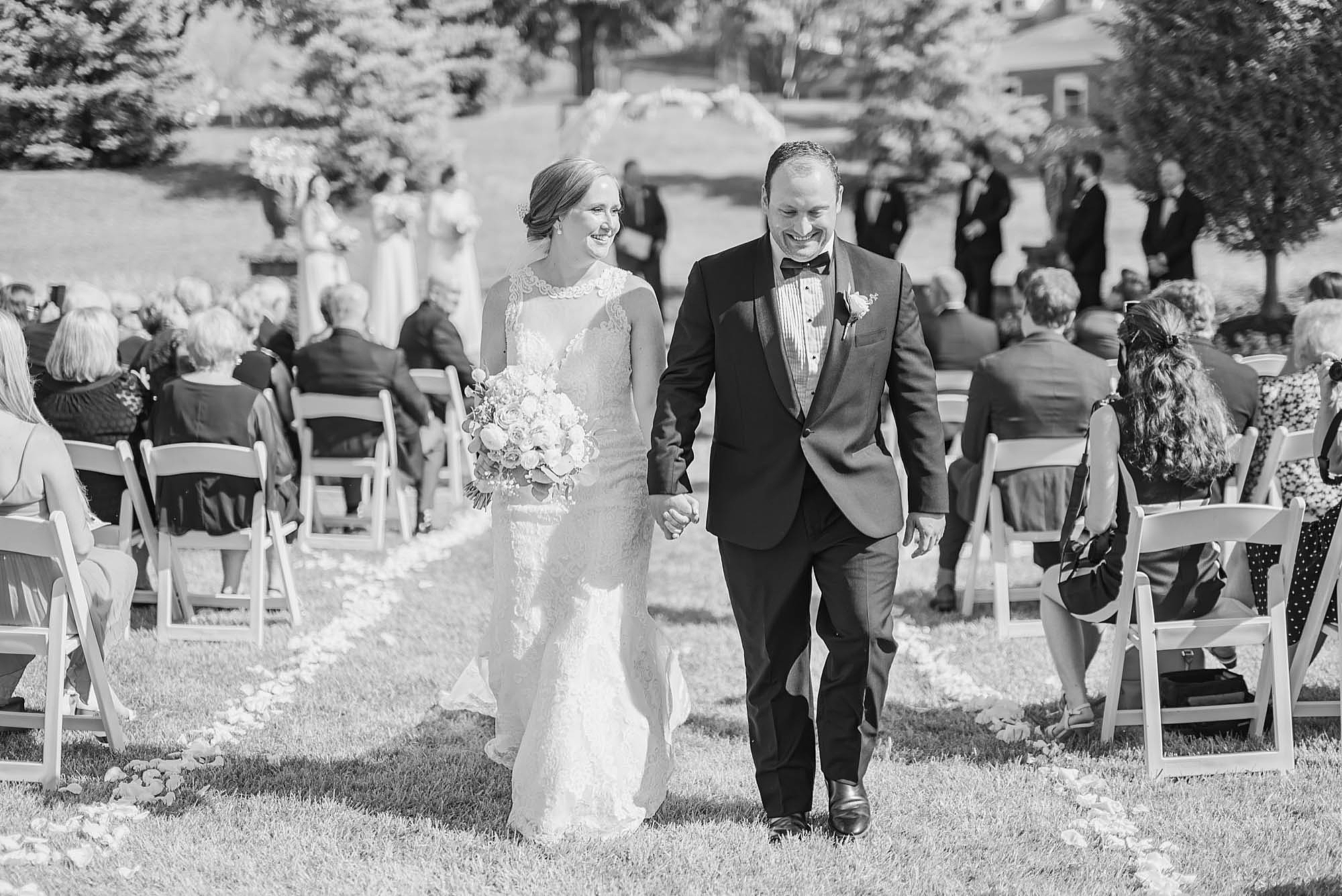 newlyweds walk up the aisle at Wedgewood Golf & Country Club
