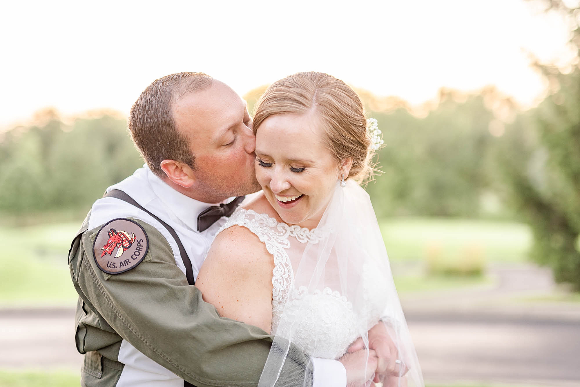 groom kisses bride during wedding portraits at Wedgewood Golf & Country Club