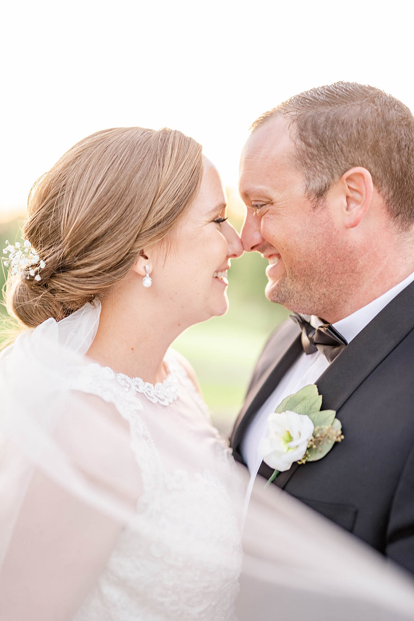 bride and groom stand nose to nose during portraits in Ohio