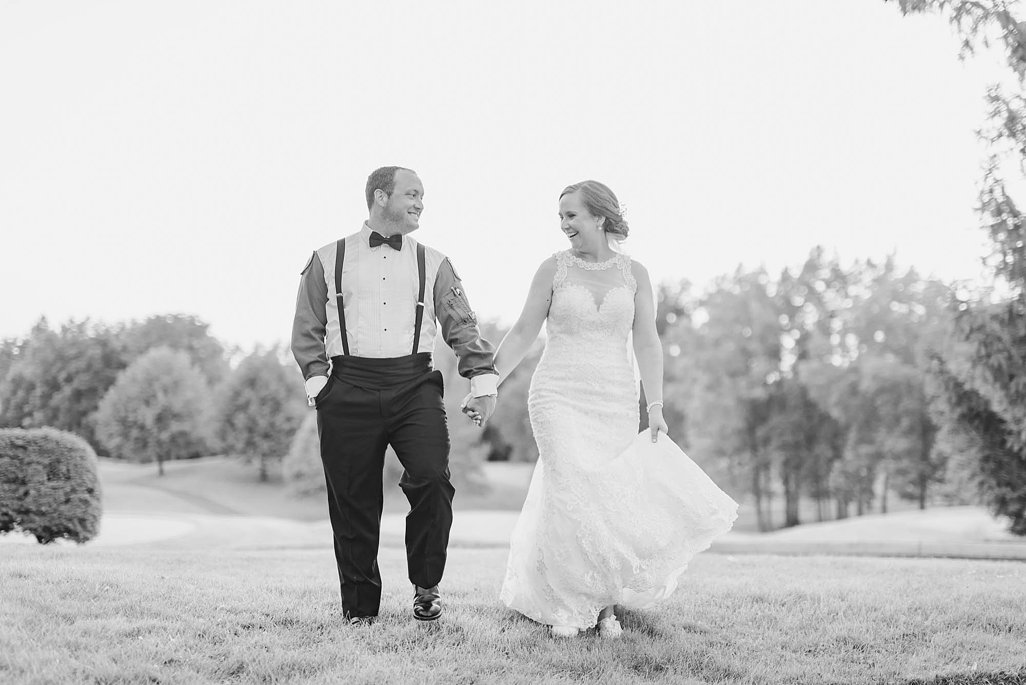 bride and groom walk along property at Wedgewood