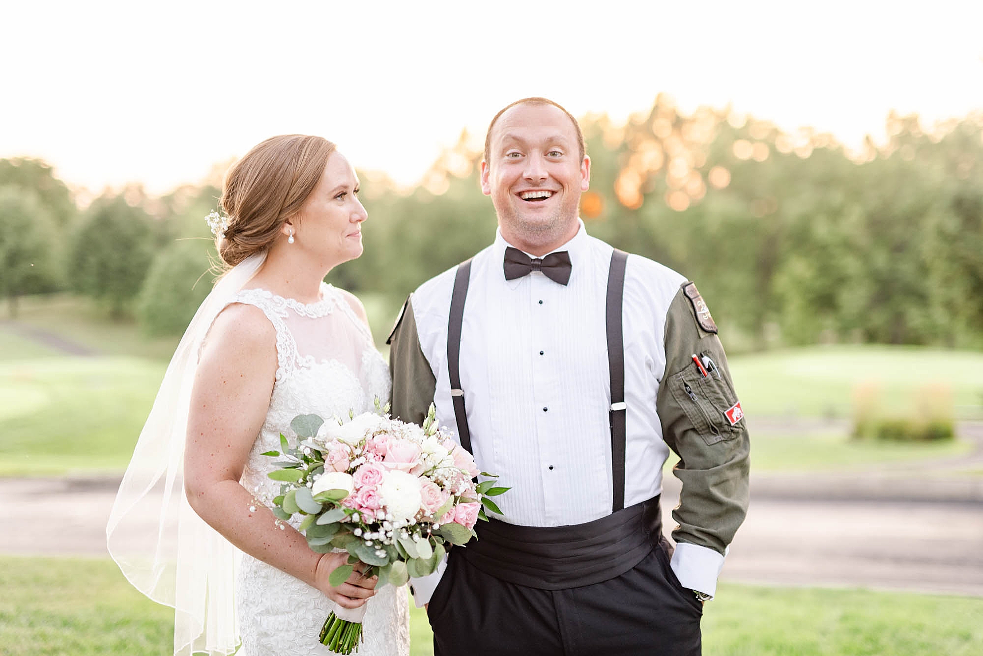 groom laughs during wedding portraits at Wedgewood