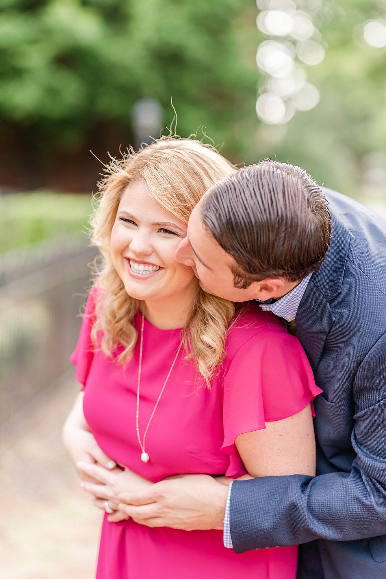 groom kisses bride to be on the cheek during engagement photos in Ohio