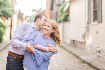 groom kisses the side of bride's head during portraits at Schiller Park