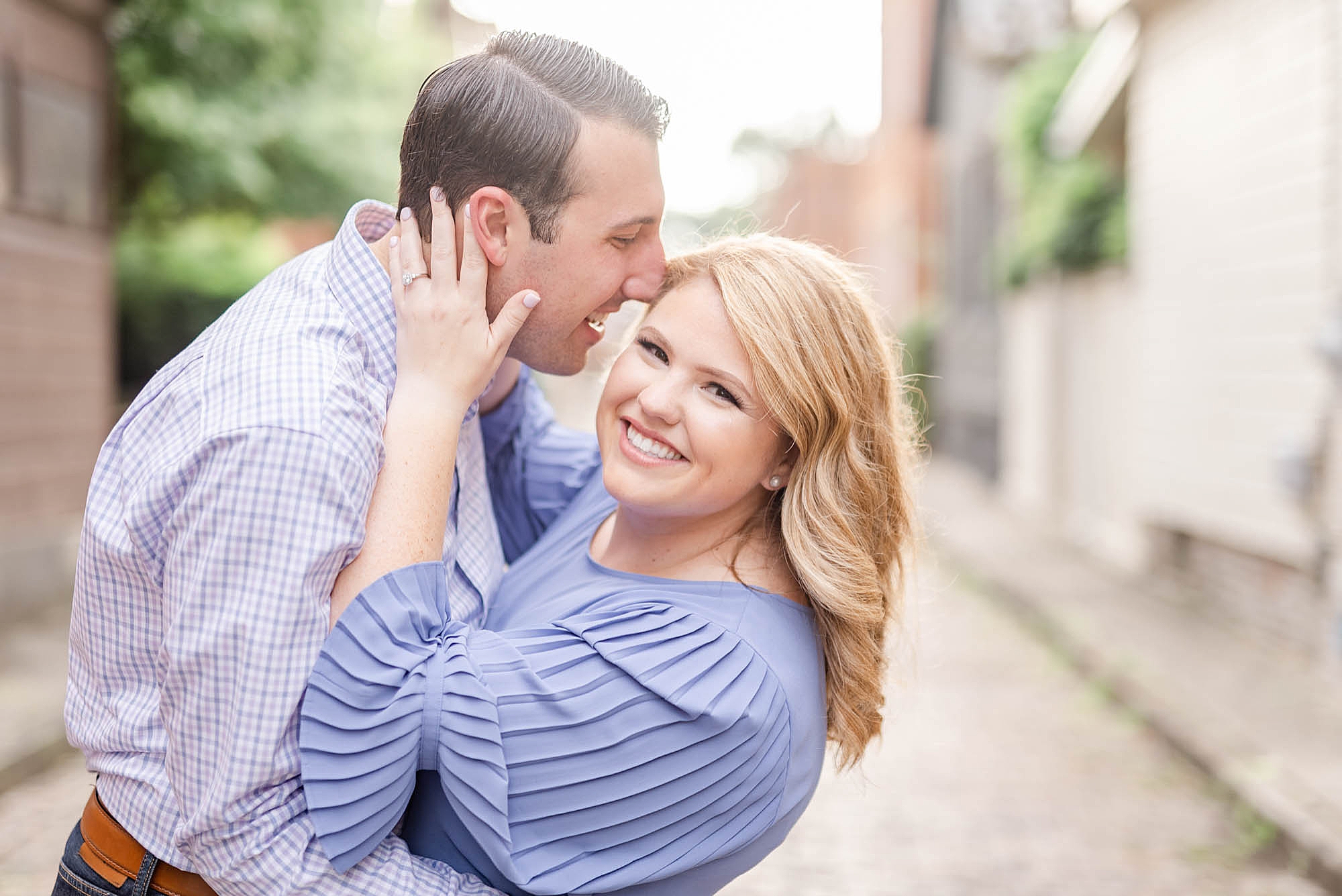 groom nuzzles bride's forehead during Schiller Park engagement photos