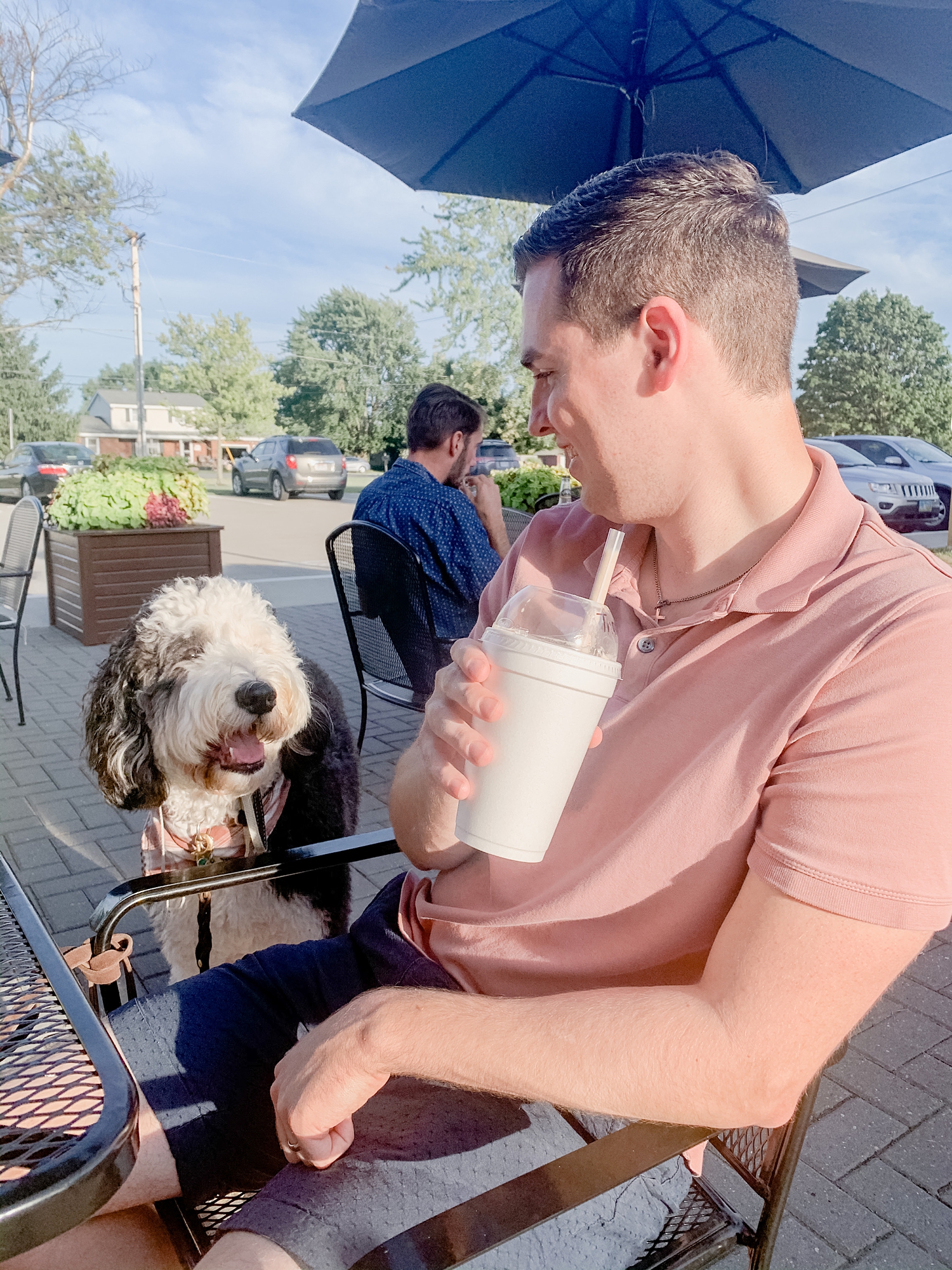 husband poses with dog at Ohio restaurant