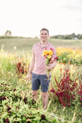 husband holds flower bouquet at Ohio garden