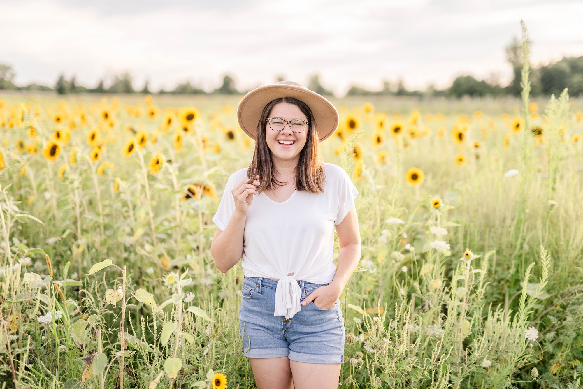 online photography educator poses in sunflower field at U-Pick Flowers